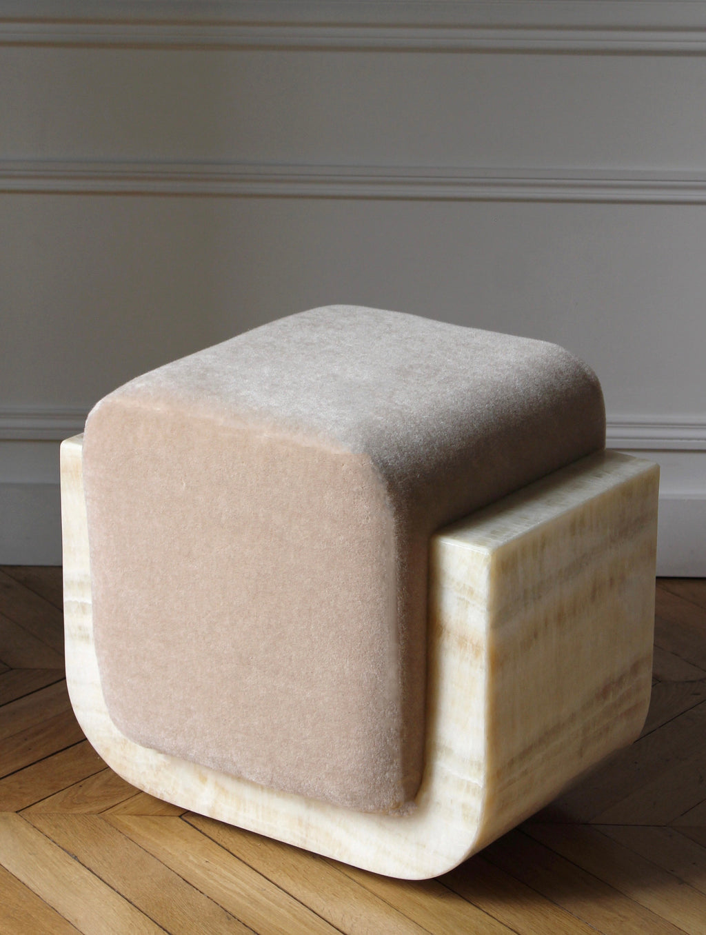 Close-up detail of ivory onyx mohair Oggy stool showing premium marble base and soft fabric texture