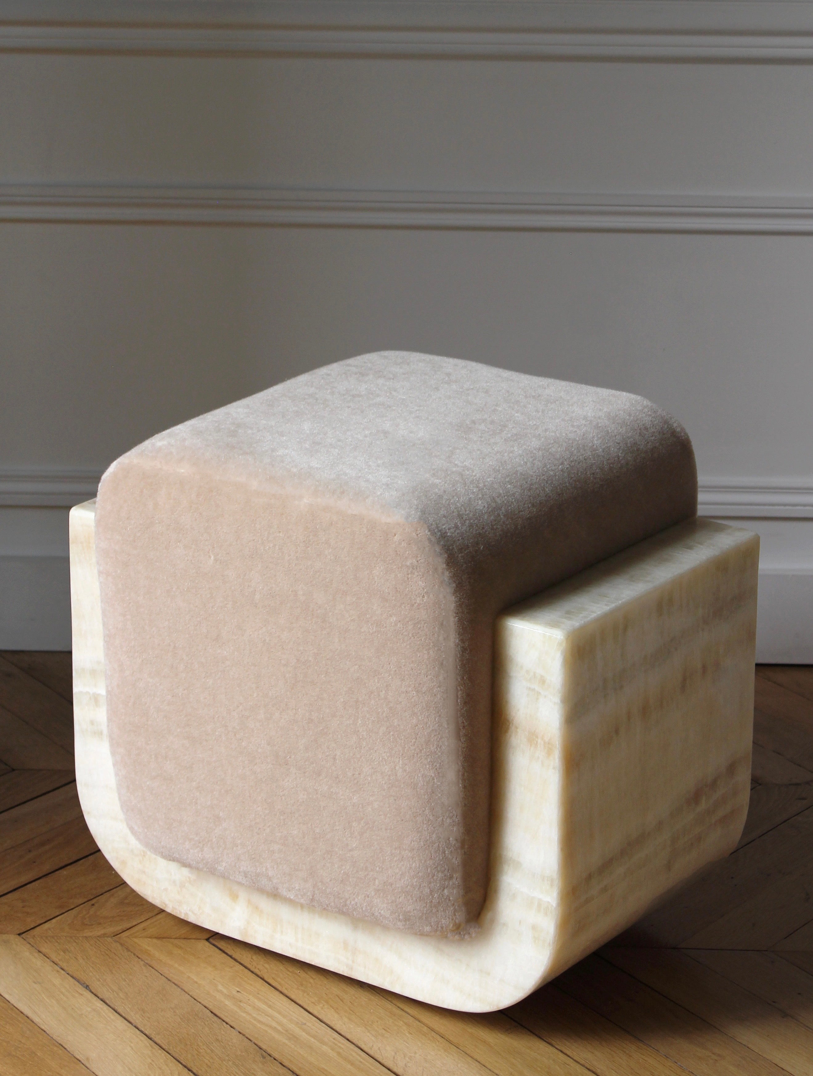 Close-up detail of ivory onyx mohair Oggy stool showing premium marble base and soft fabric texture