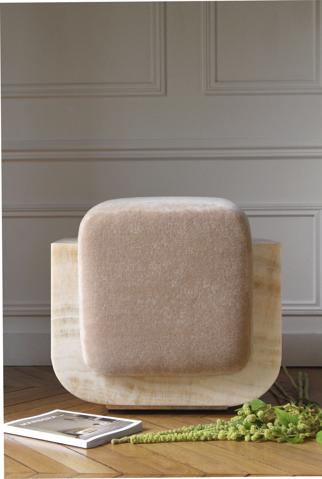 Side angle view of ivory onyx mohair Oggy stool displaying Italian marble craftsmanship and luxury design