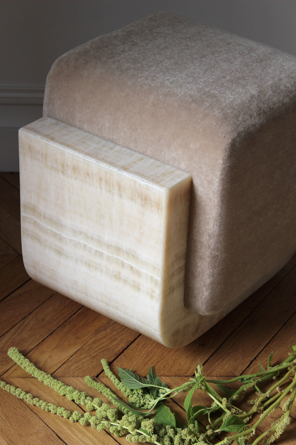 Alternative perspective of ivory onyx mohair Oggy stool highlighting marble veining and mohair upholstery