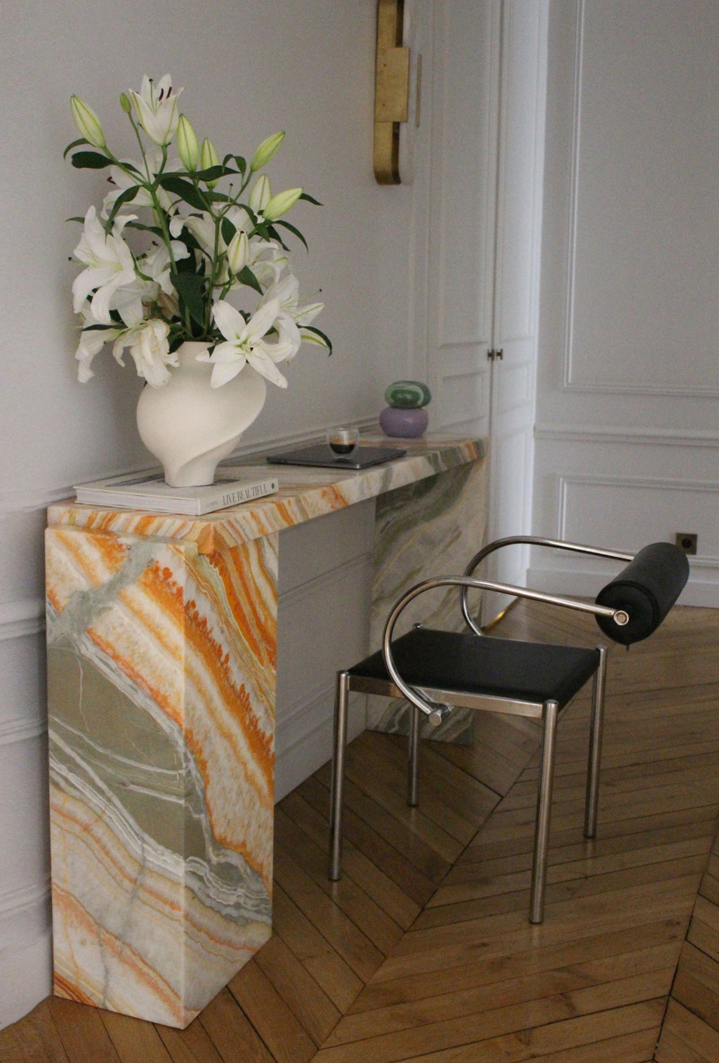 Jill console Rainbow Onyx marble showcasing dramatic multicolored veining and premium Italian craftsmanship