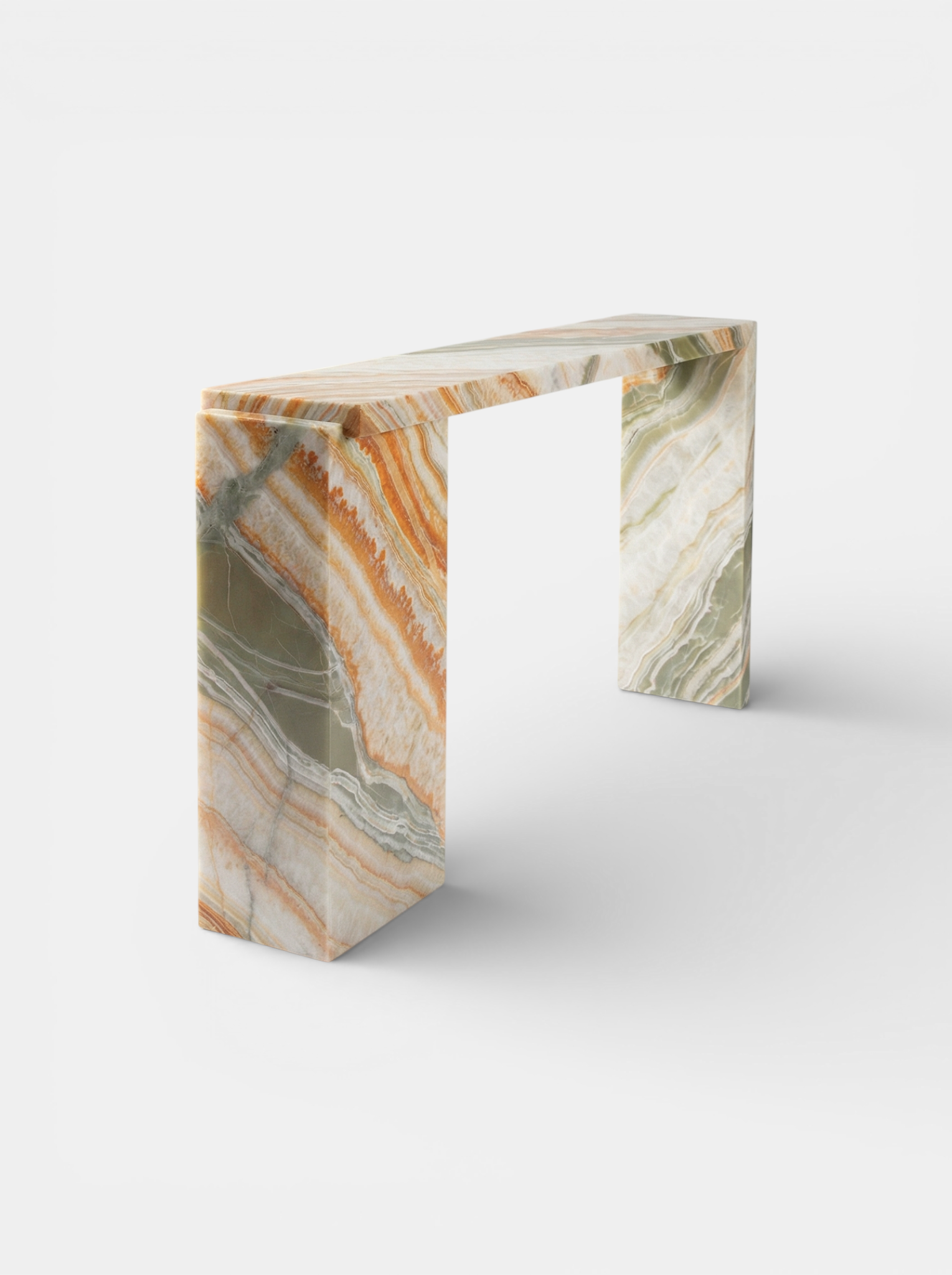 Three-quarter left view Rainbow Onyx Jill console highlighting dramatic marble patterns and modern form