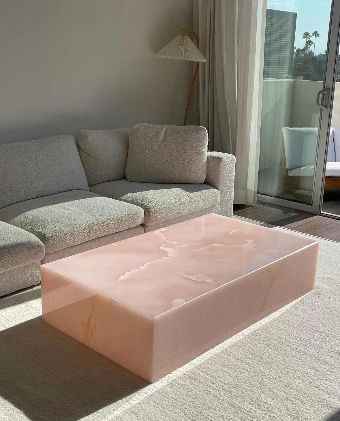 Elegant pink onyx Bubble Gum table - handcrafted Italian marble coffee table side perspective view