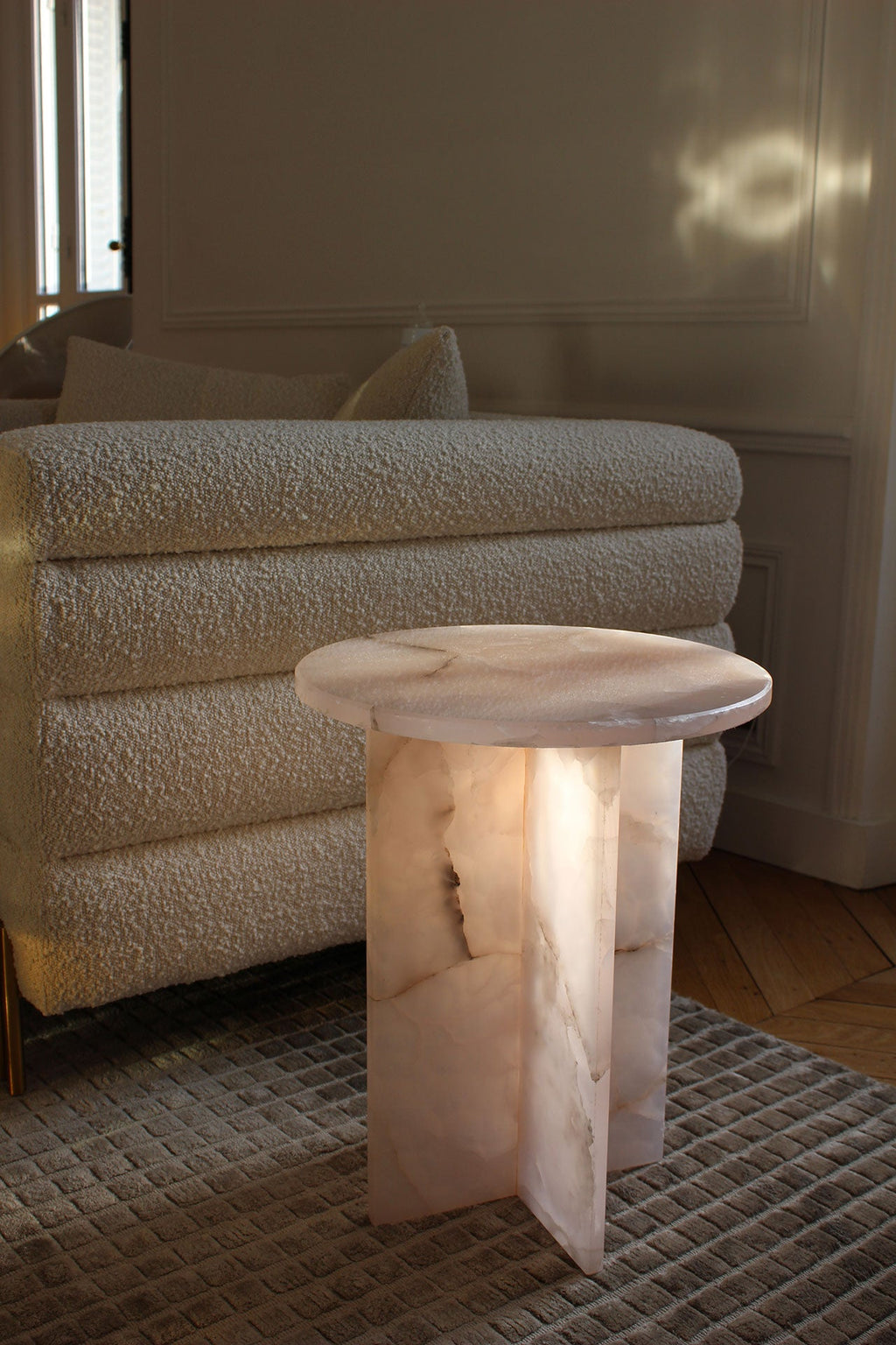Lifestyle view of pink onyx Rosie table in modern interior setting showing elegant proportions and style