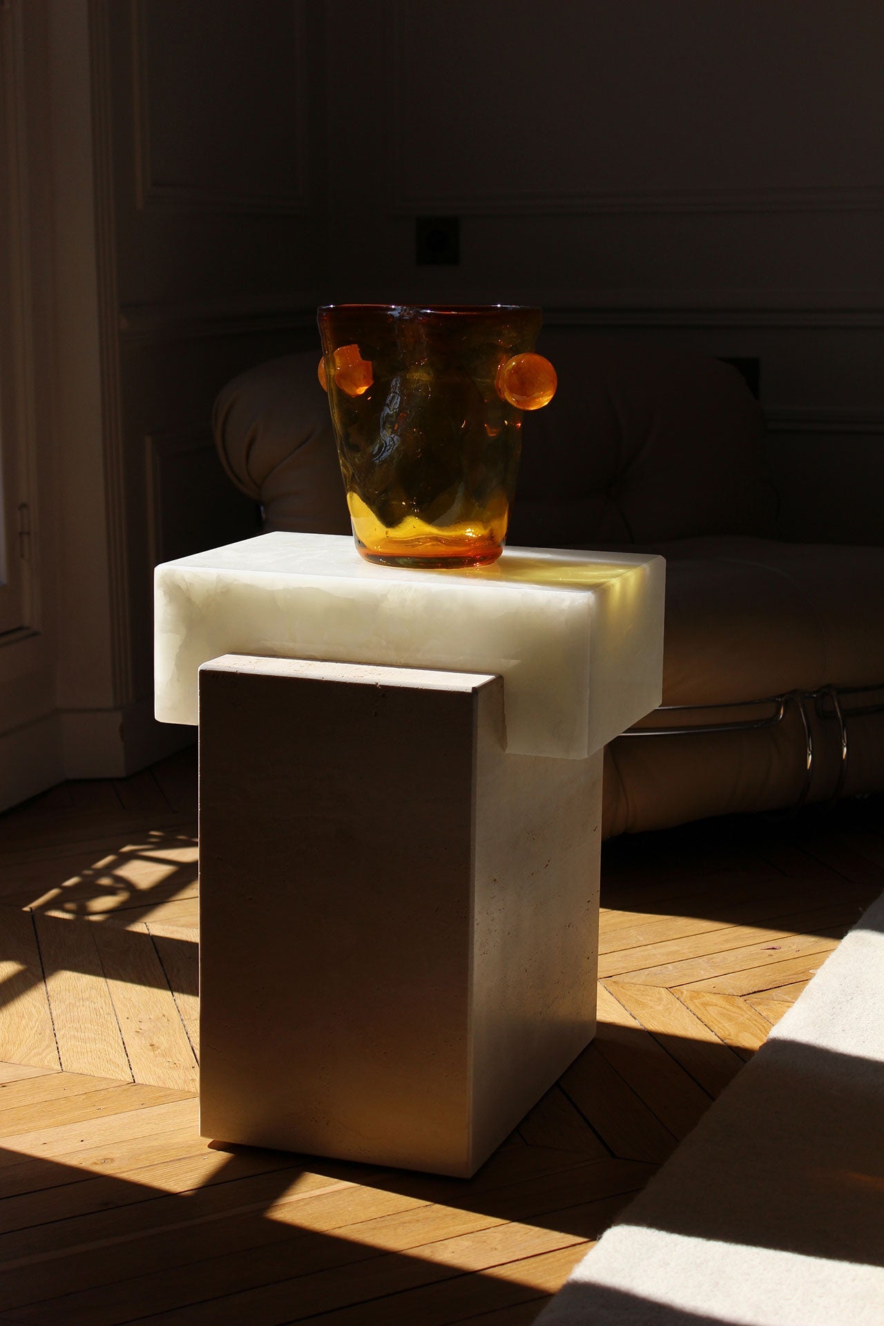 White onyx travertine coffee table in contemporary interior setting with modern decor and natural light
