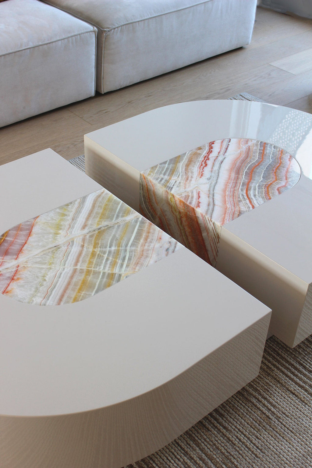 Rainbow onyx and wood capsule coffee table lifestyle view in contemporary interior setting