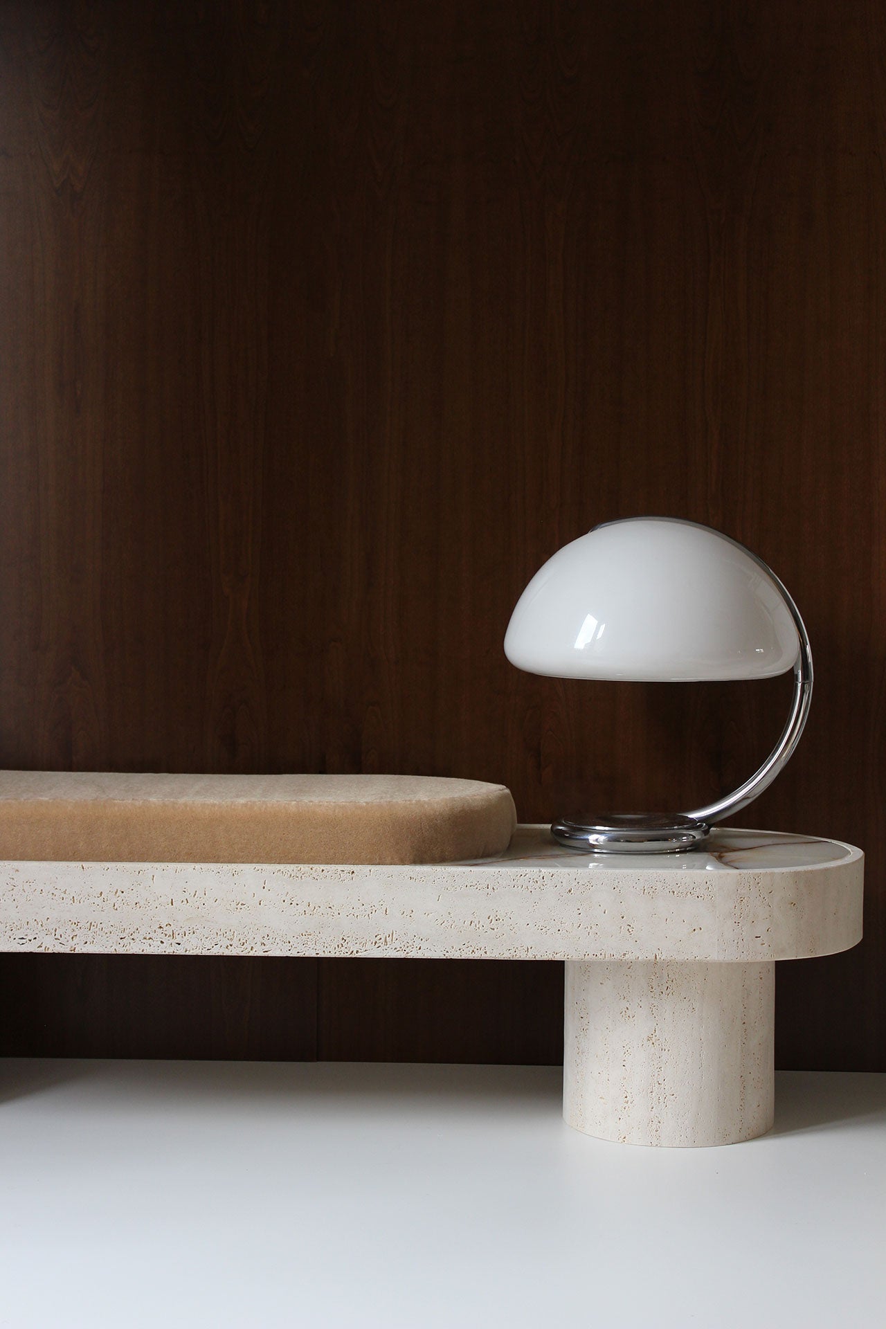 Angled view of Noto mohair bench with travertine marble base, Italian crafted luxury furniture