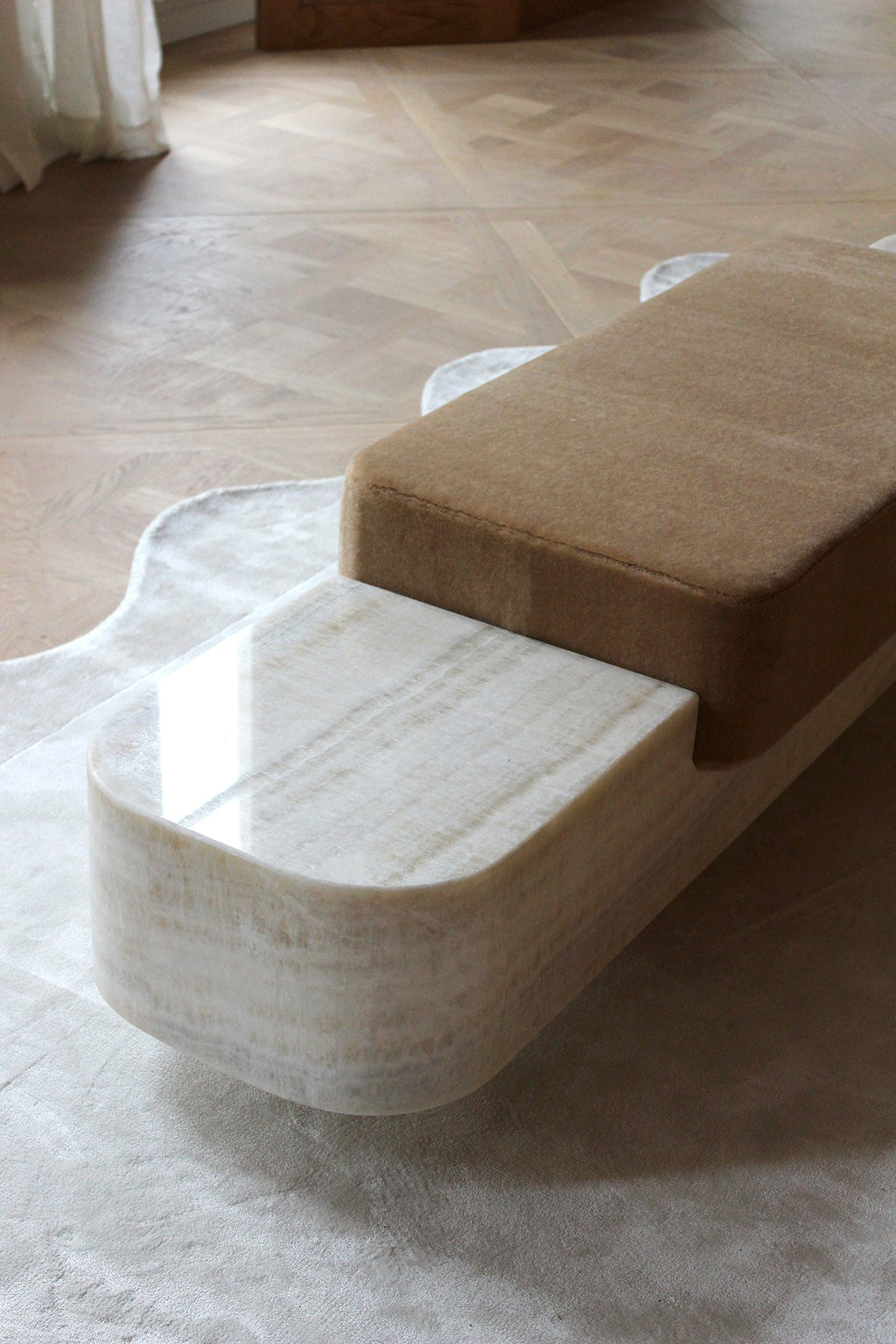 Side angle view of Ran luxury marble bench highlighting premium stone craftsmanship and smooth finish