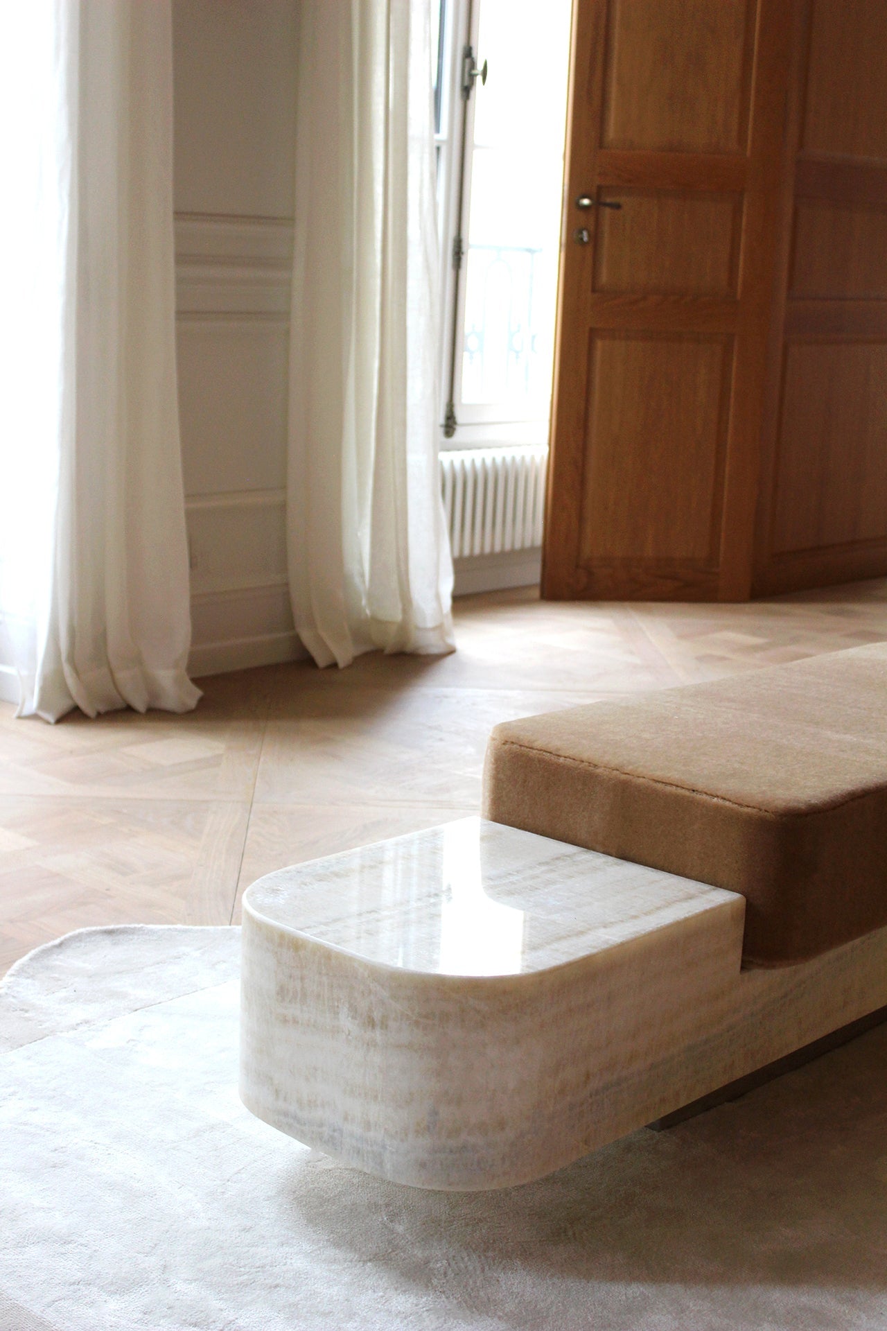 Detail shot of Ran marble bench showing natural stone texture and Italian artisan craftsmanship