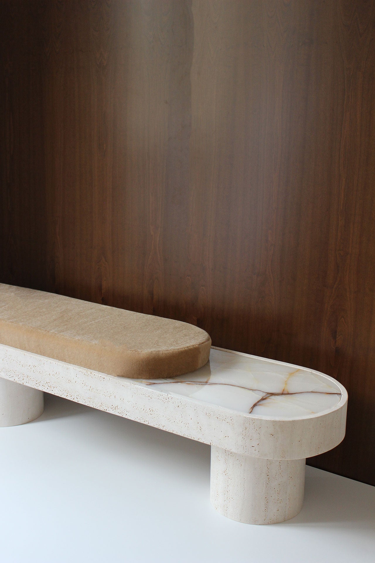 Side view of Noto mohair bench with travertine marble base, Italian luxury furniture craftsmanship