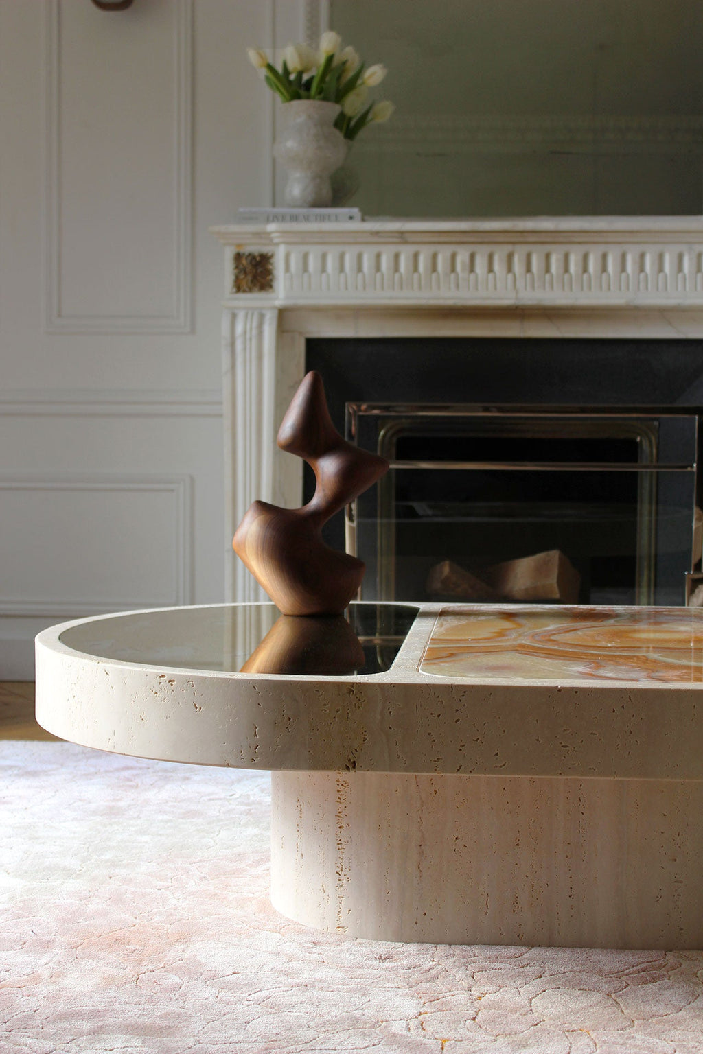 Side angle of Cohesion coffee table highlighting travertine and sixties onyx material contrast
