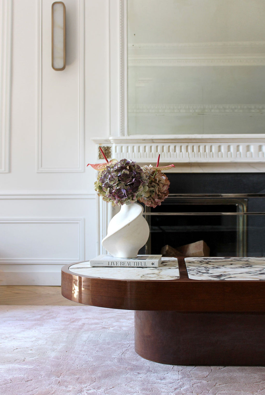 Close-up of wood and Calacatta Viola marble junction showing premium Italian craftsmanship details