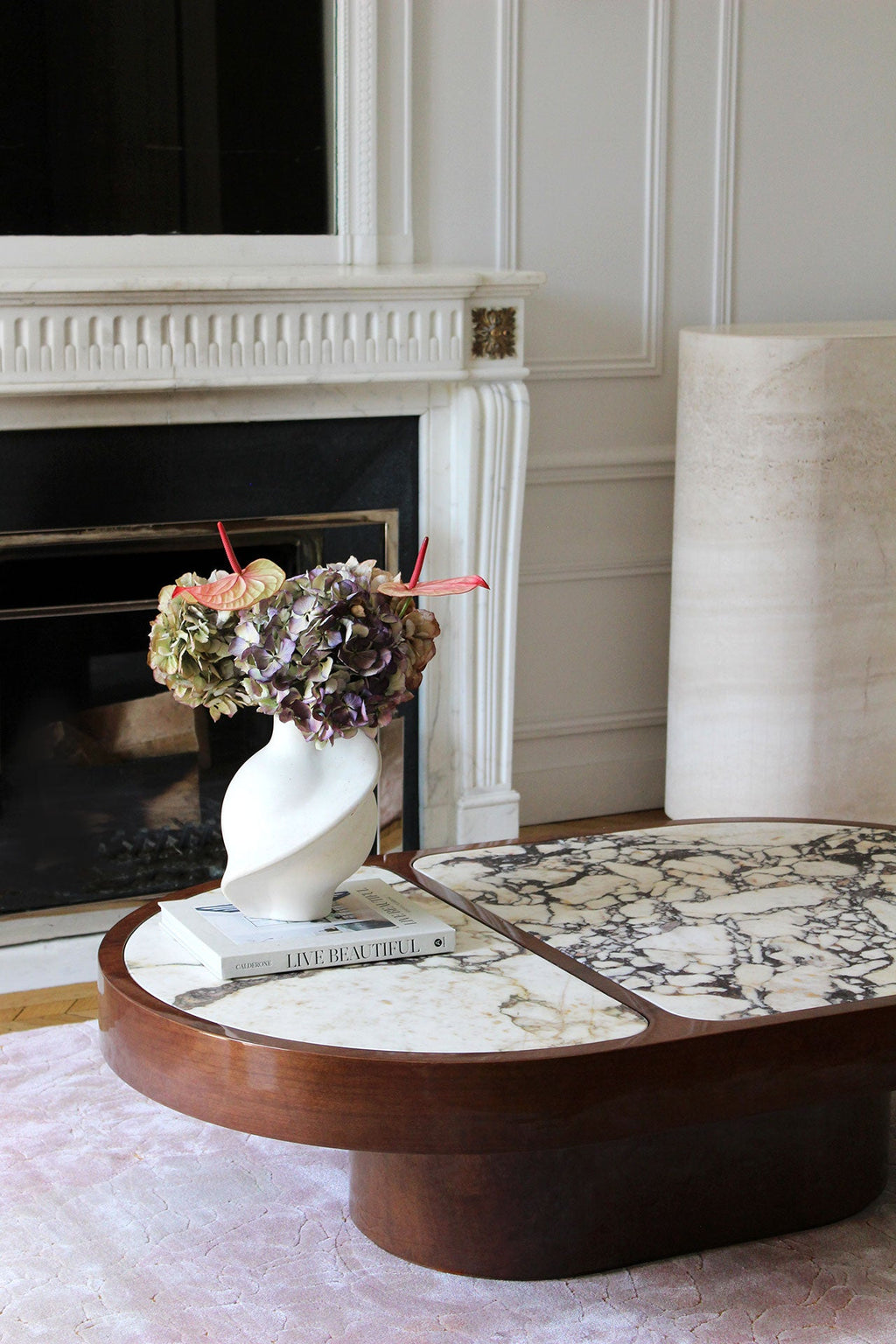 Detailed view of Calacatta Viola marble's distinctive purple veining on wooden coffee table base