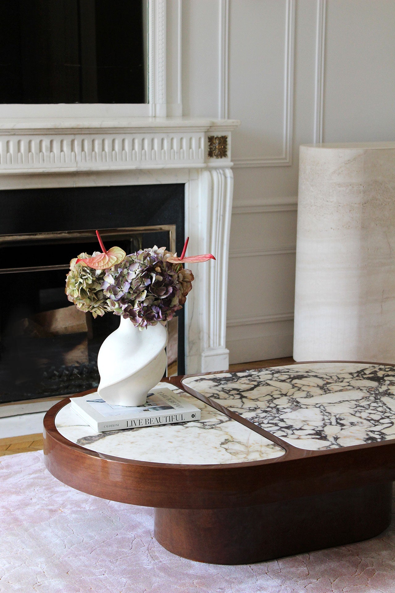 Detailed view of Calacatta Viola marble's distinctive purple veining on wooden coffee table base