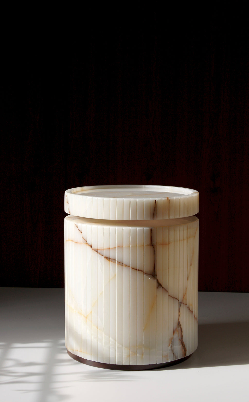 Elegant Drey onyx side table showcasing translucent marble properties - premium Italian stone furniture
