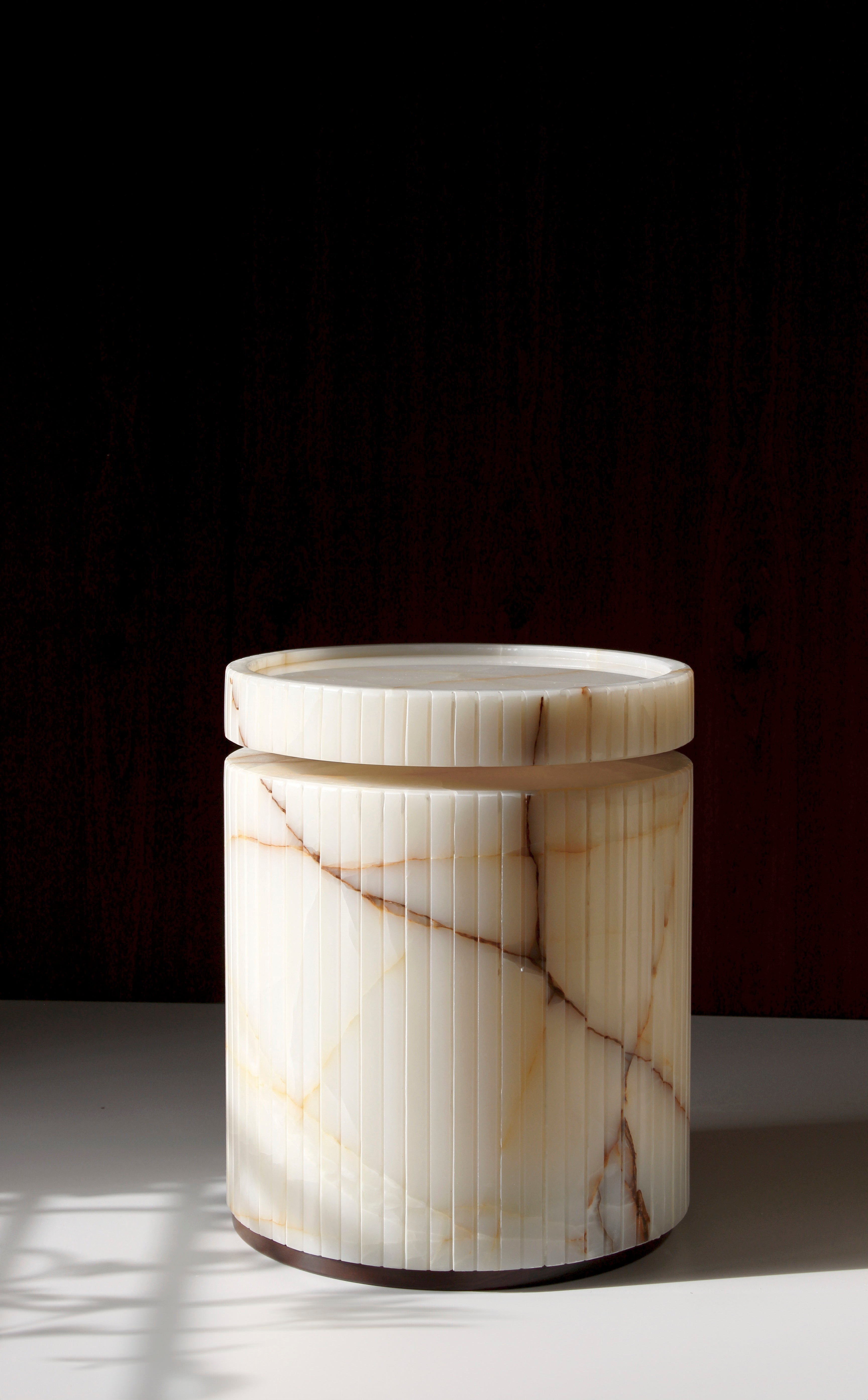Elegant Drey onyx side table showcasing translucent marble properties - premium Italian stone furniture