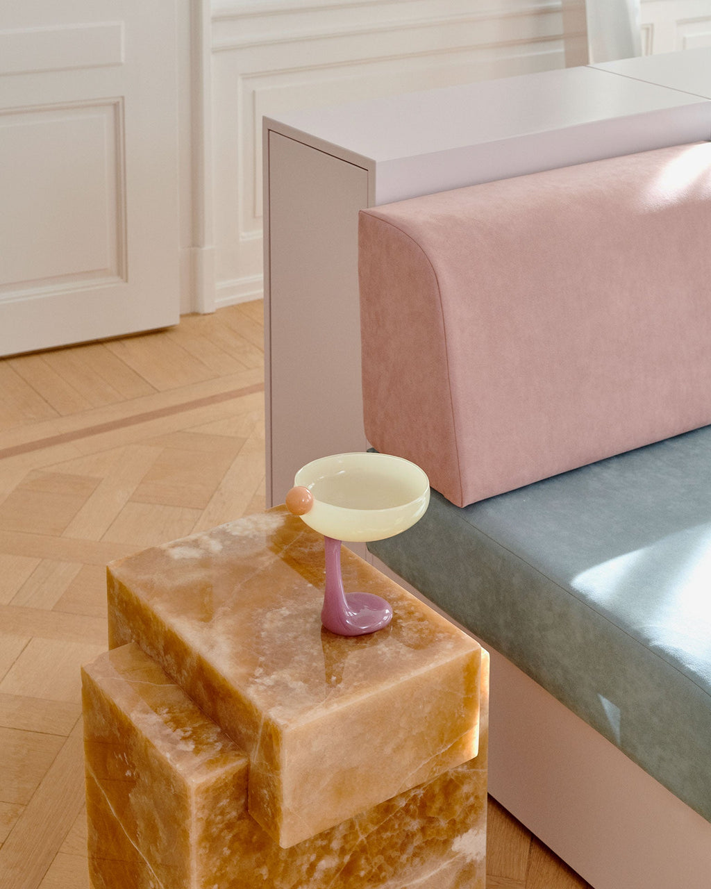 Honey onyx marble table in contemporary interior setting displaying warm golden stone characteristics