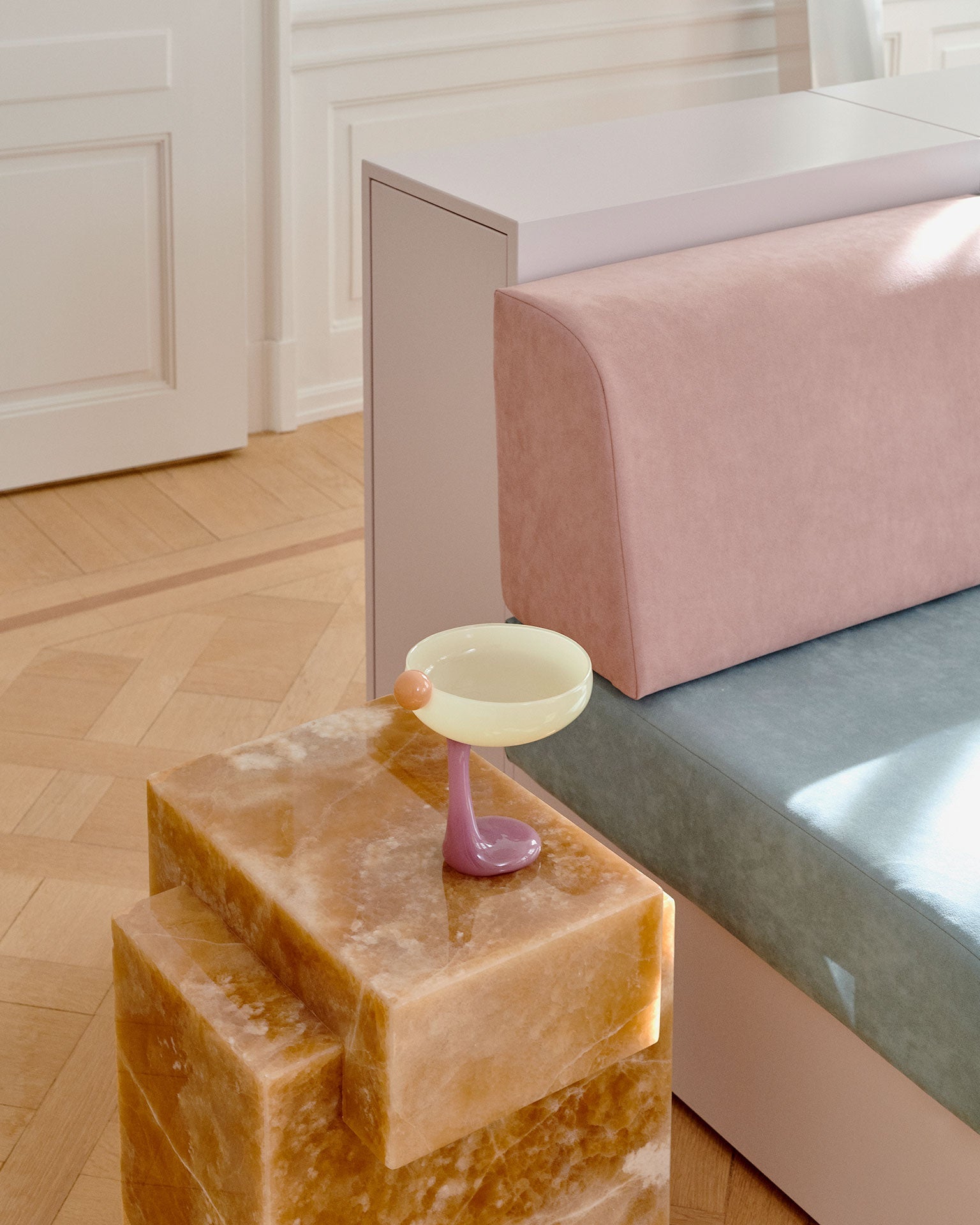 Honey onyx marble table in contemporary interior setting displaying warm golden stone characteristics