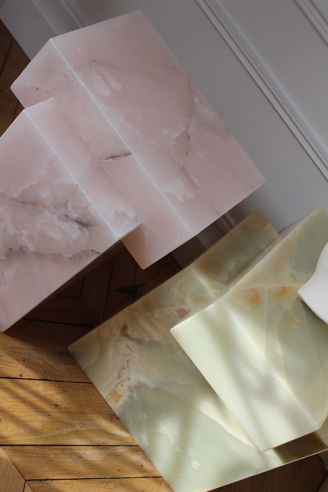 Gaia green and pink onyx tables paired together in contemporary living space interior design scene