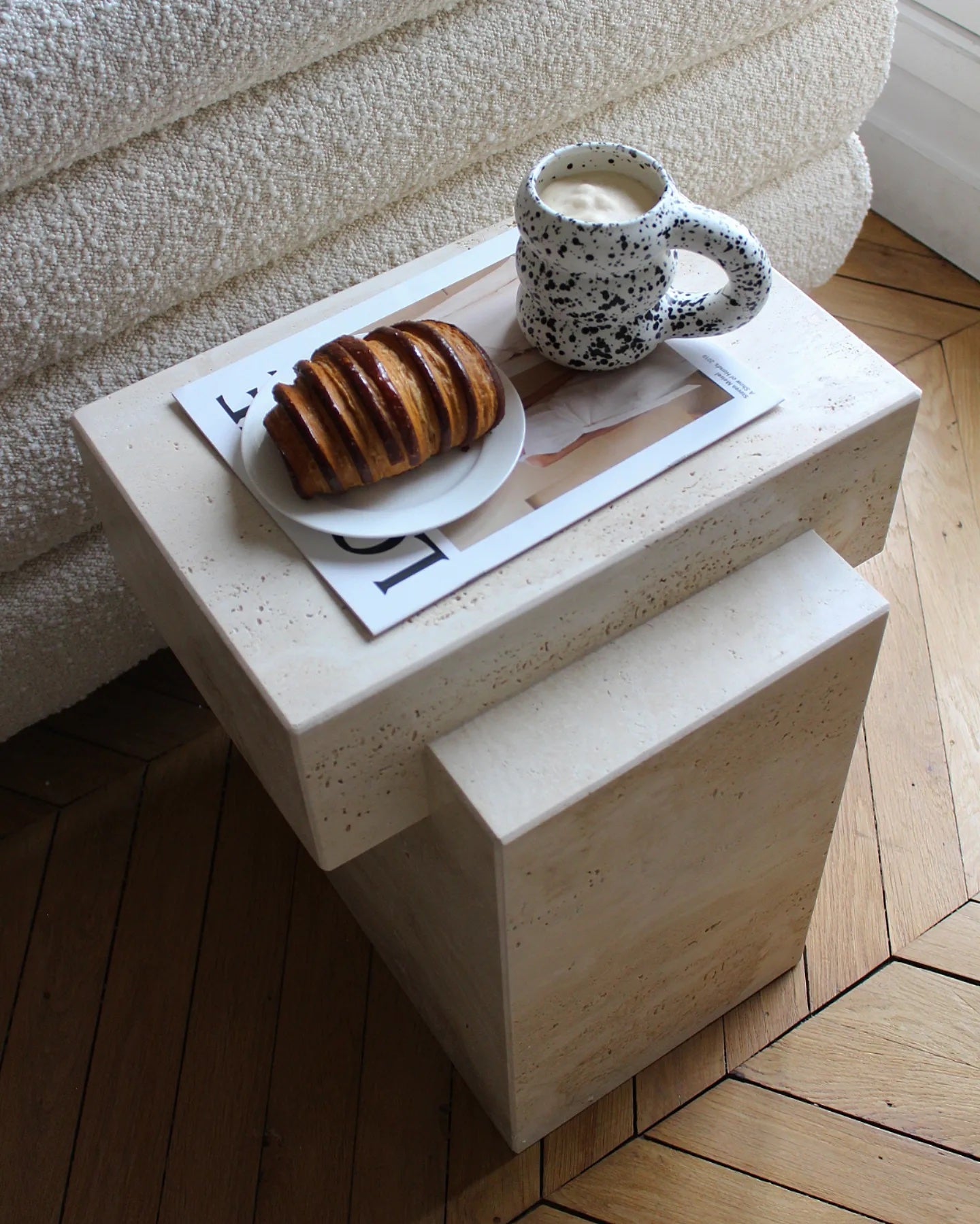 Elegant travertine table styled in minimalist living space showcasing natural marble characteristics