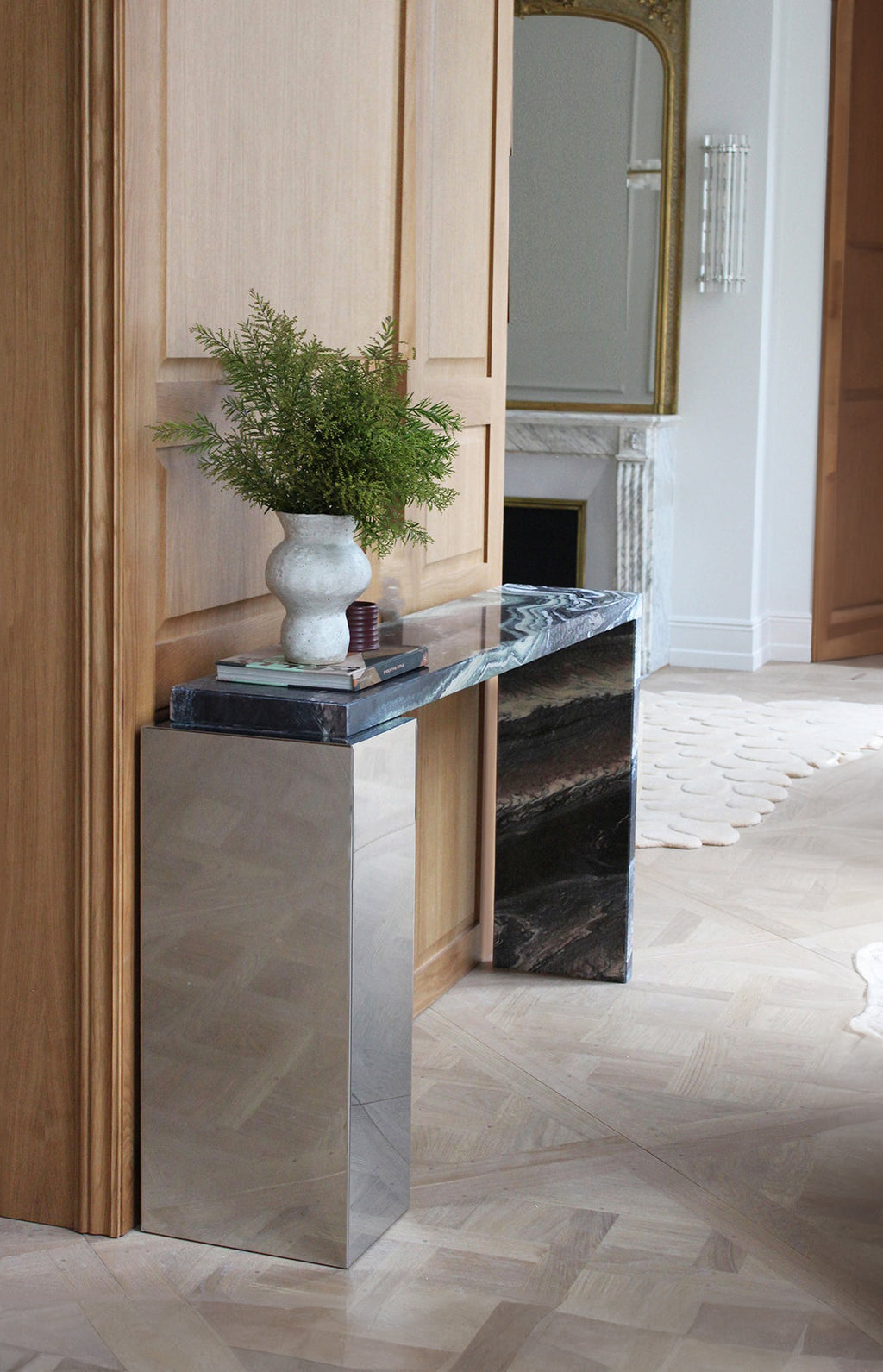Lifestyle photo of Jill console in Cipolino marble displaying natural green veining and modern design