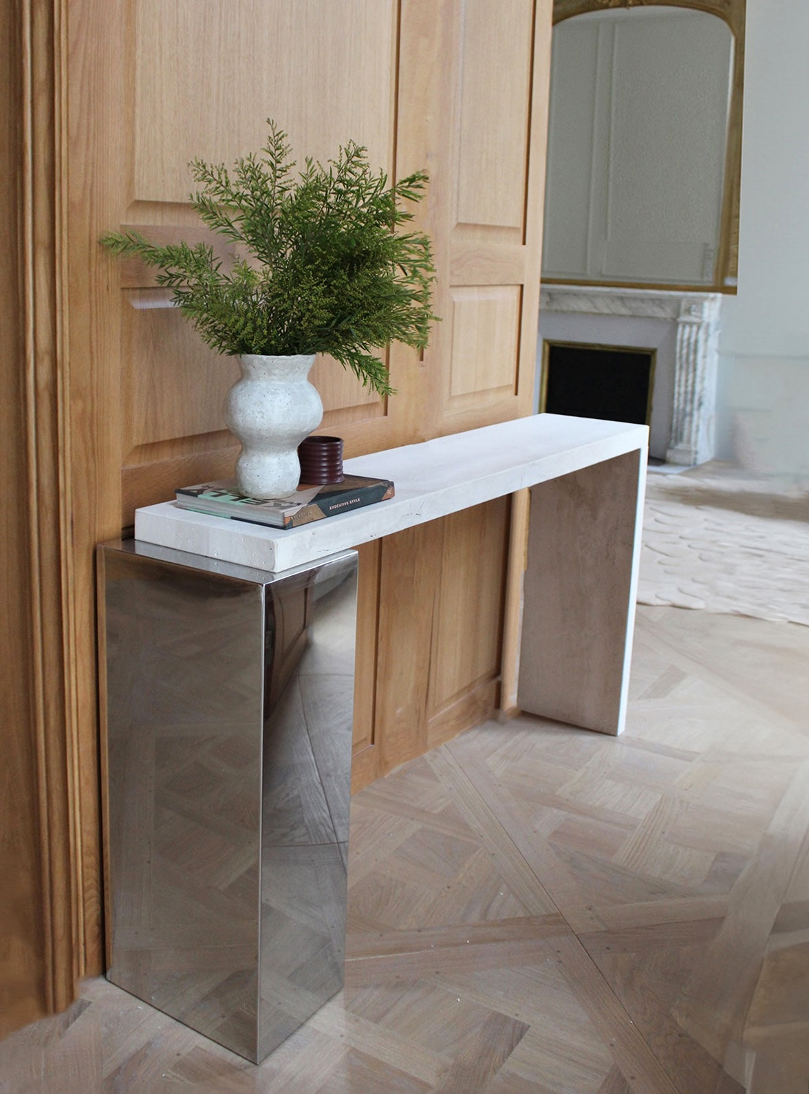 Lifestyle shot of Jill console in travertine marble showcasing warm stone tones and contemporary design