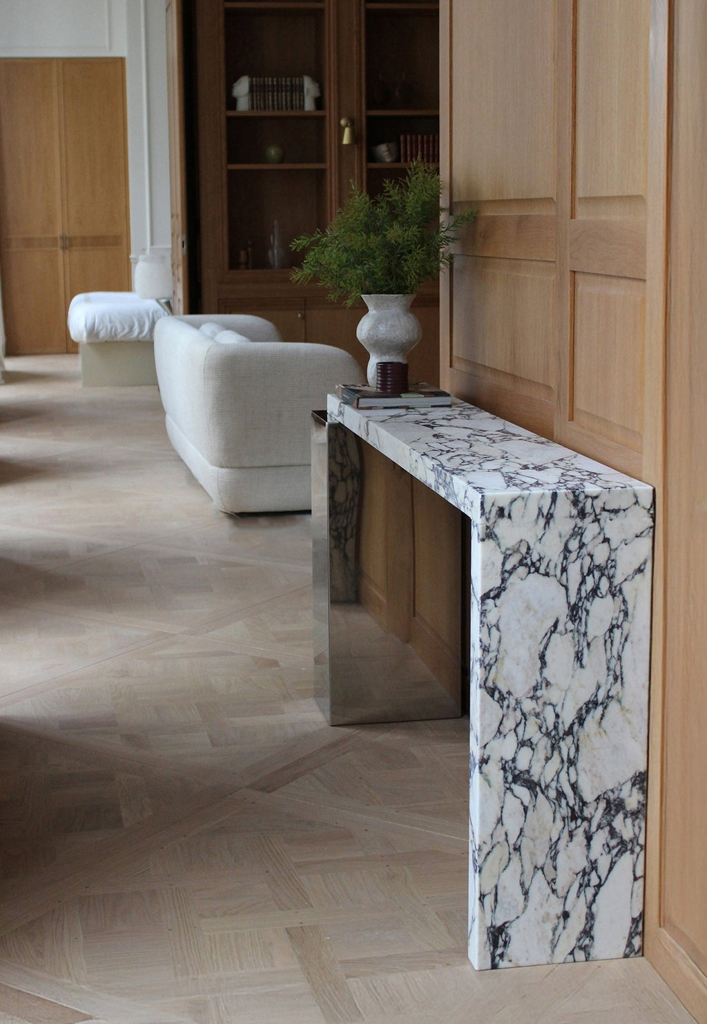 Detail shot of Jill console Calacatta Viola marble surface with distinctive violet veining and inox finish