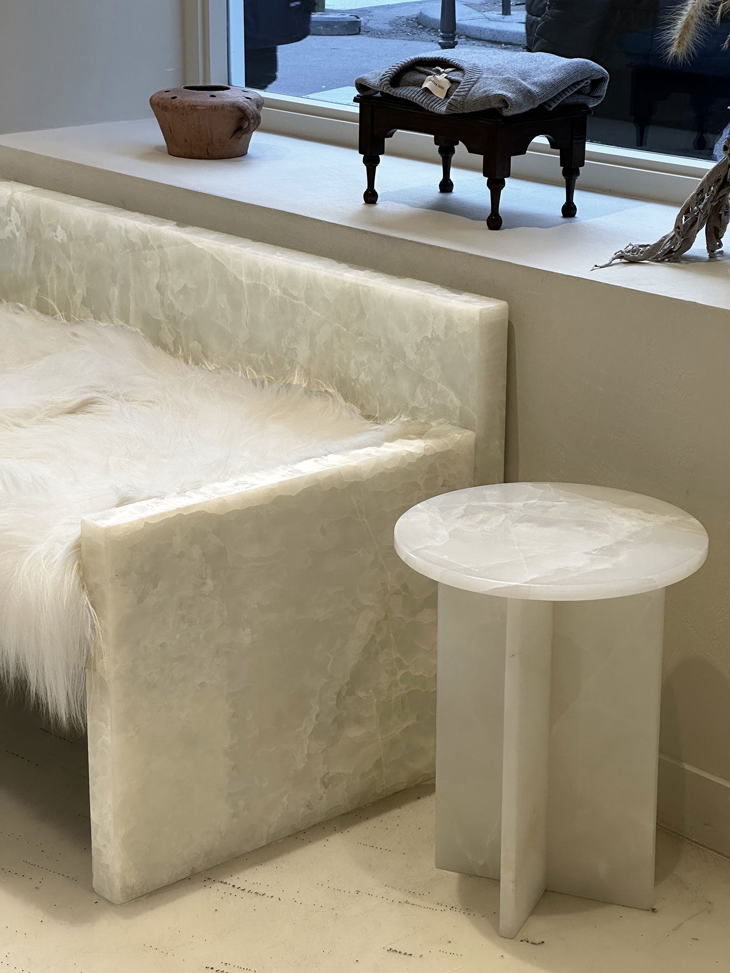 Interior styling view of white onyx Rosie table in contemporary living space - MARBERA luxury design