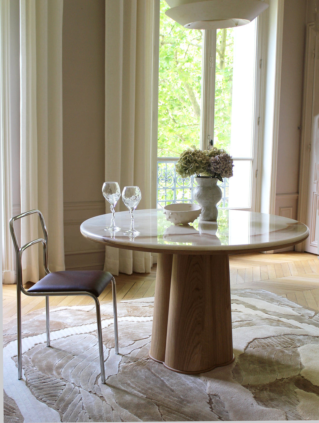 Front angle of Poli luxury table showing oak wood and vanilla onyx marble combination design