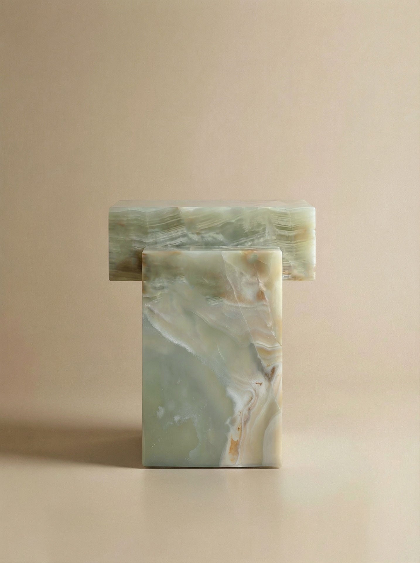 Side profile of handcrafted green onyx table highlighting the organic curves and Italian marble quality