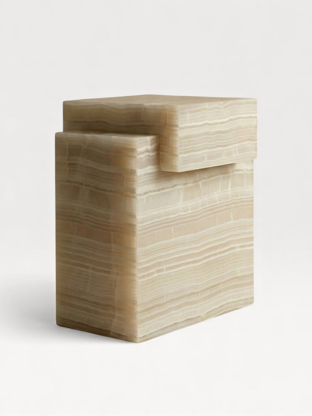 Front detail view of handcrafted ivory onyx marble table with smooth sculptural curves and veining