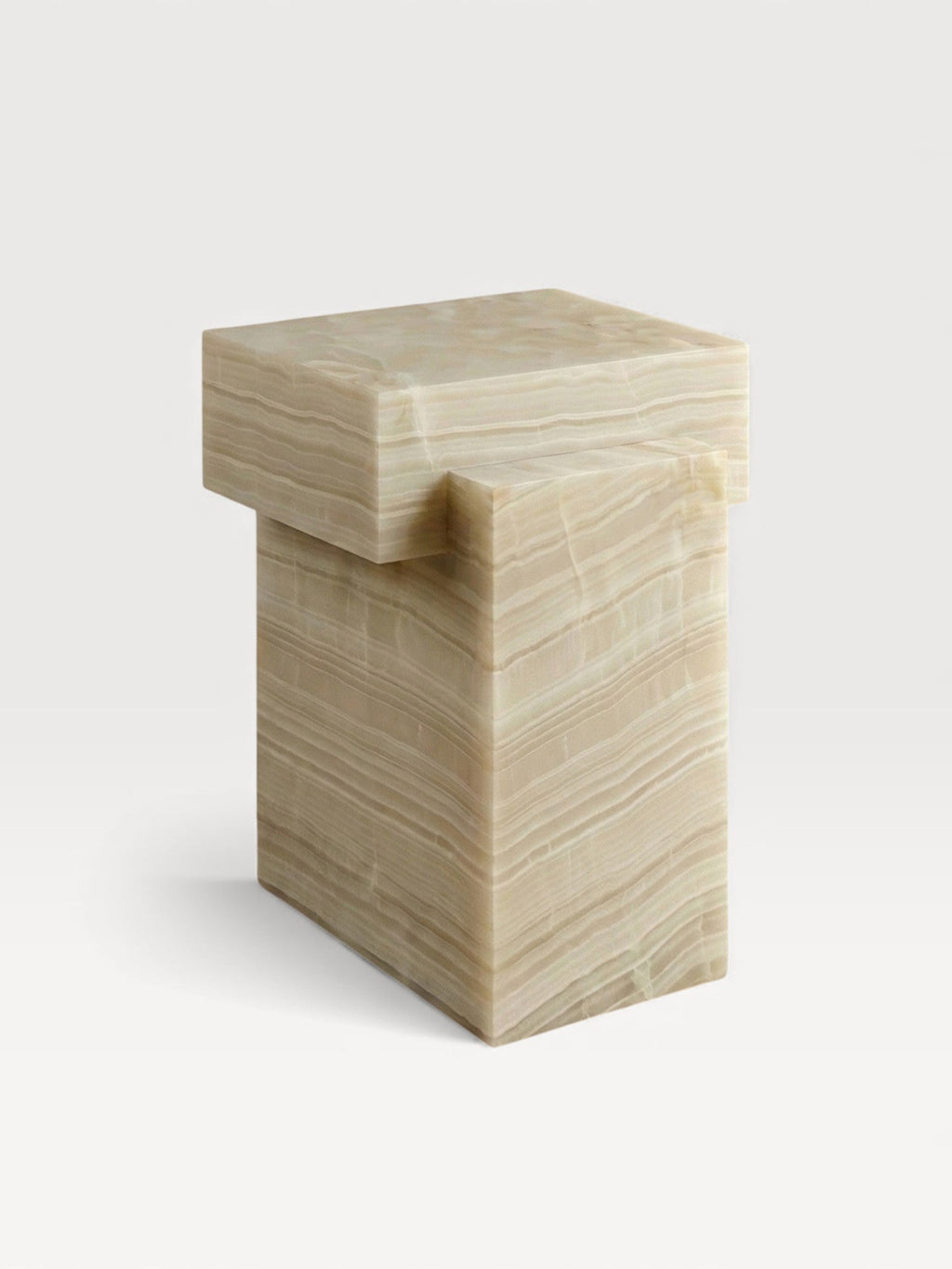 Three-quarter front view of ivory onyx table showing natural stone patterns and premium quality finish