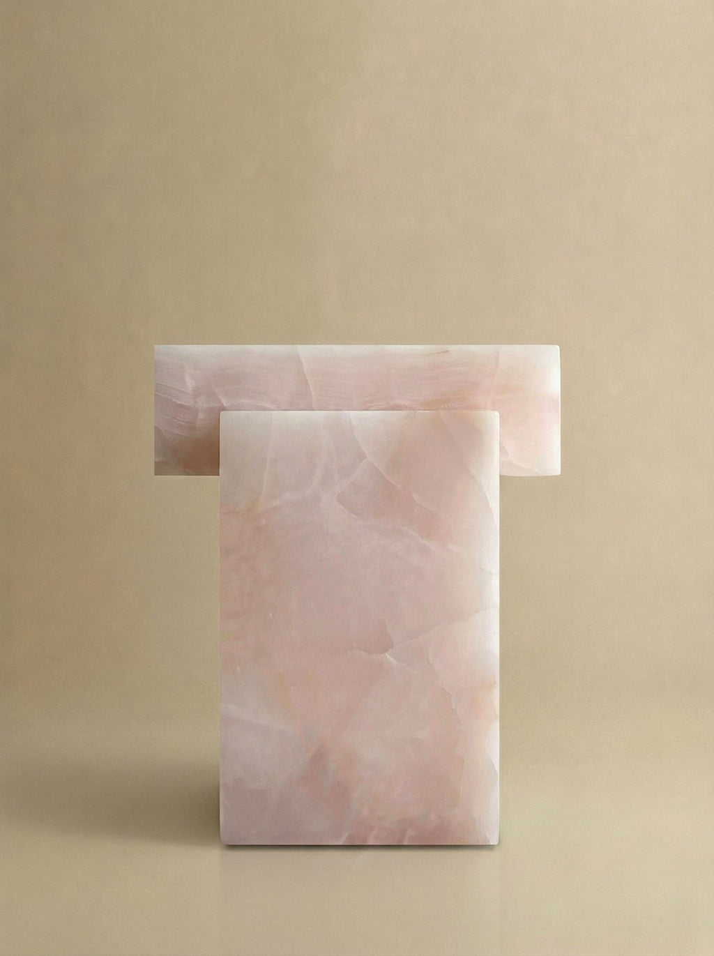 Side profile of pink onyx coffee table showcasing smooth organic form and Italian marble craftsmanship