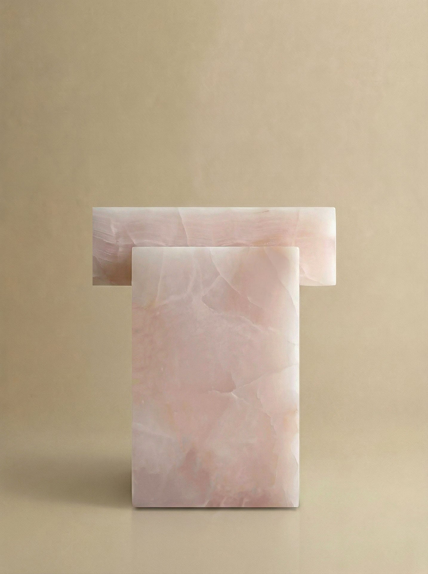 Side profile of pink onyx coffee table showcasing smooth organic form and Italian marble craftsmanship