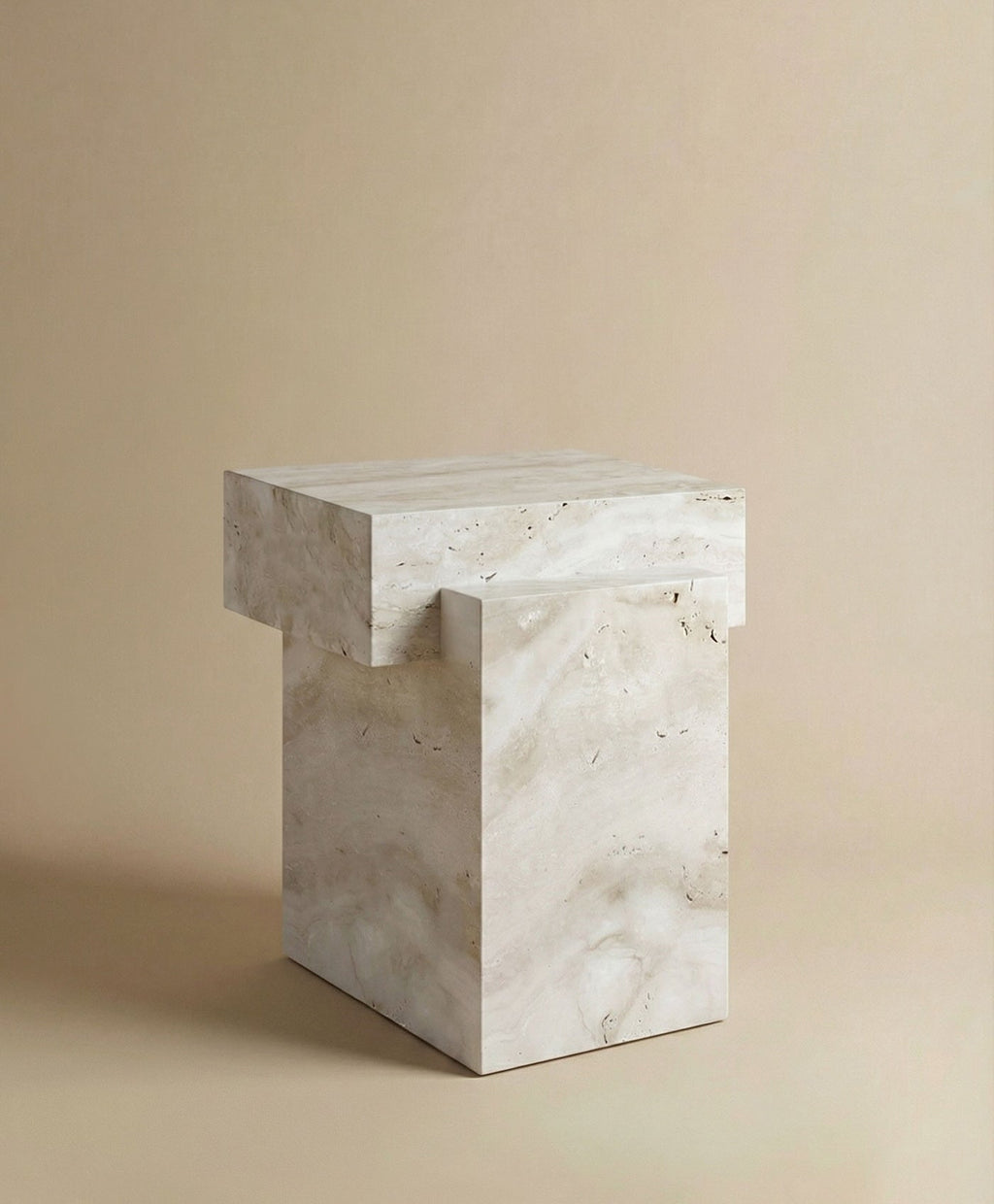 Three-quarter angle of travertine table showing natural stone texture and sculptural curved design