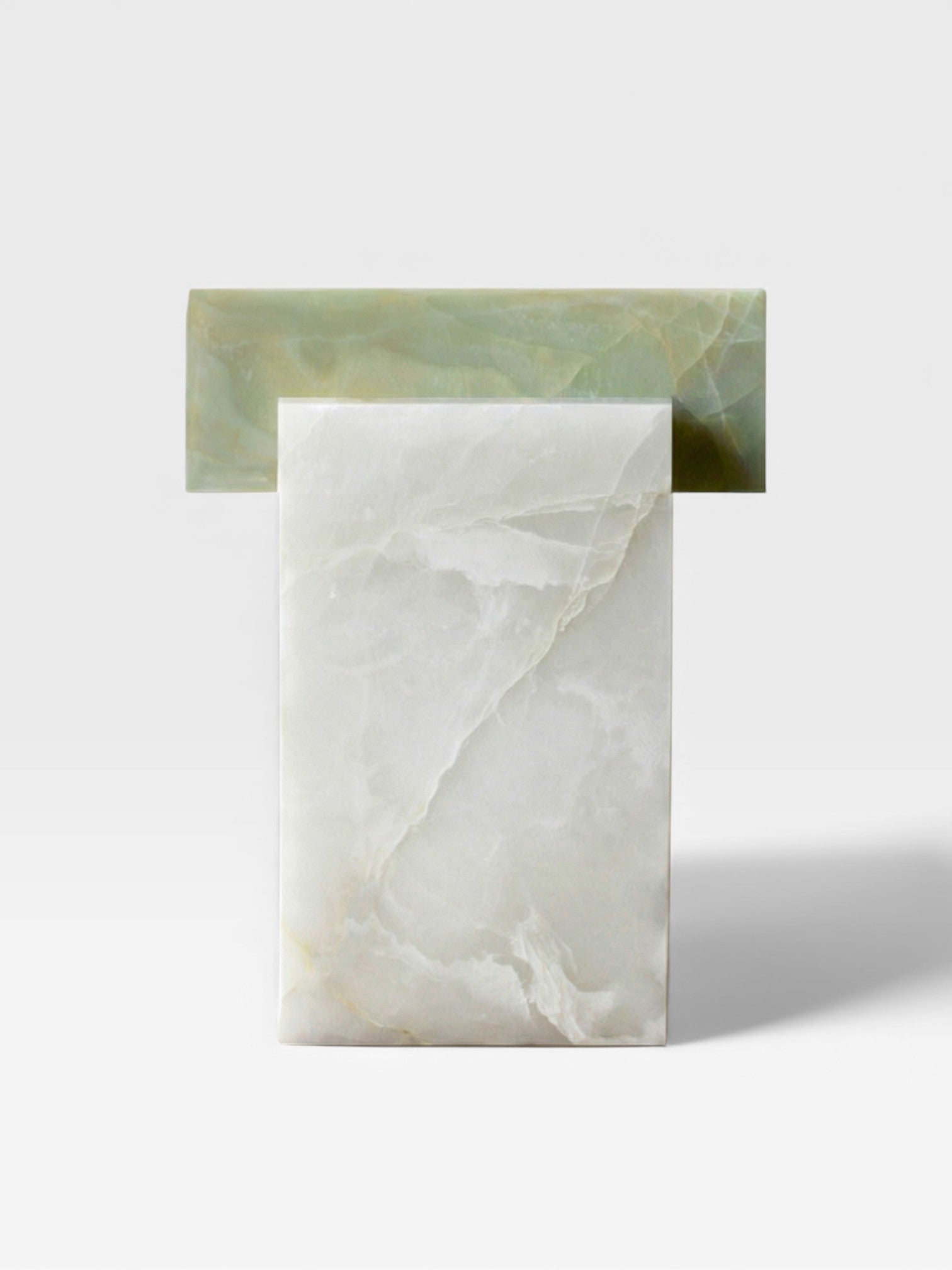 Profile view of white and green onyx table showing natural stone contrast and sculptural form details