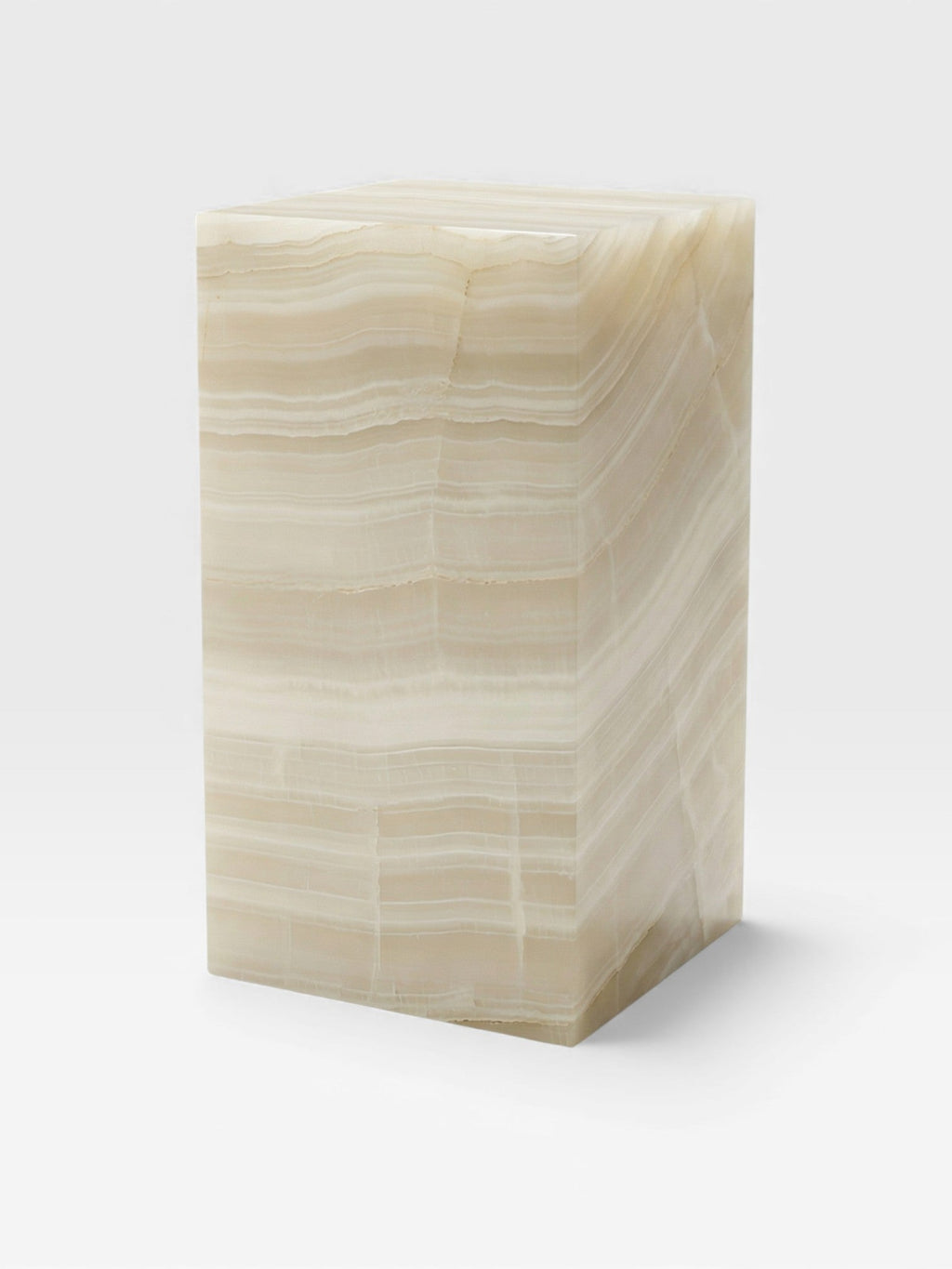 Three-quarter left view of ivory onyx plinth showcasing premium marble finish and geometric design