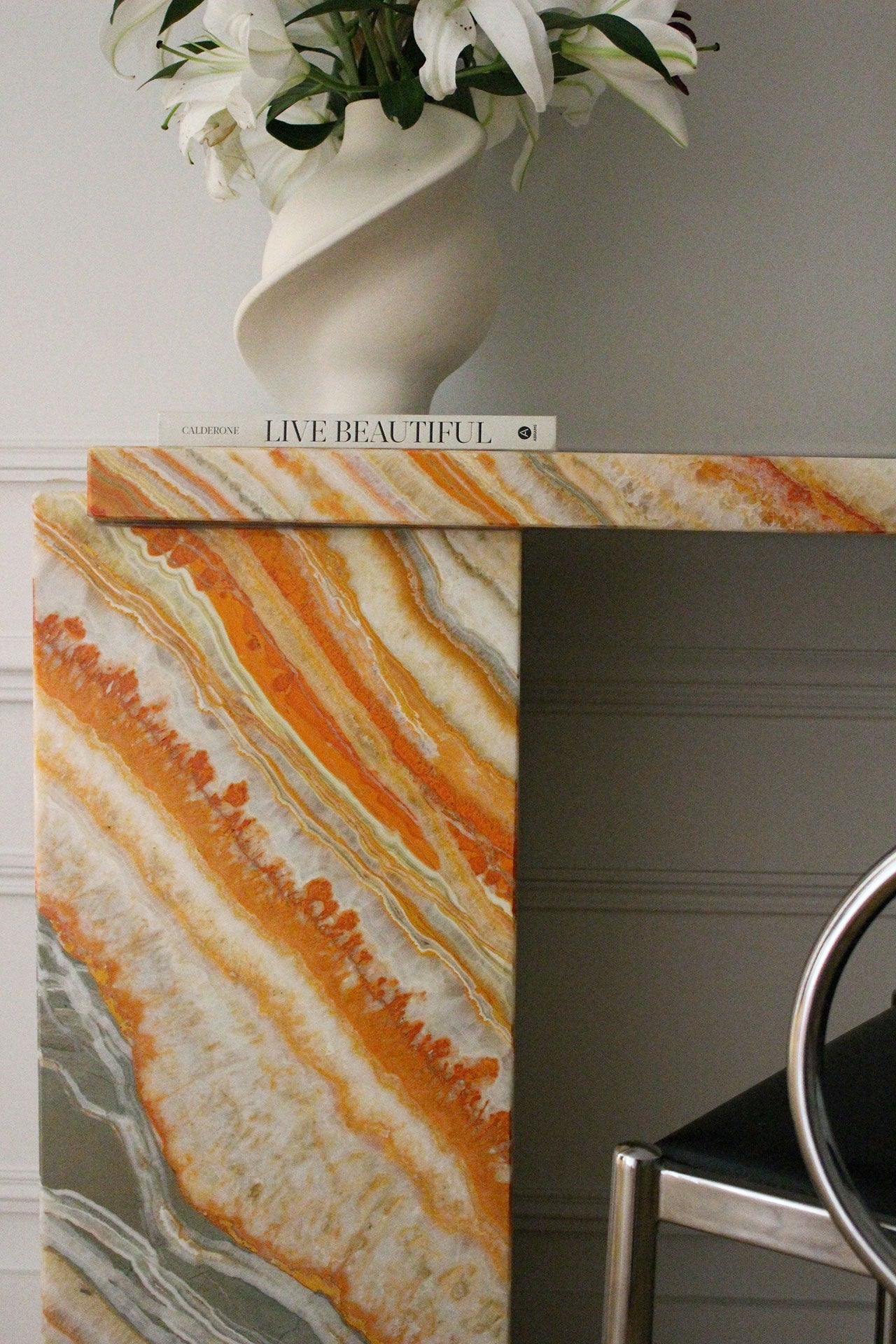 Close-up of Rainbow Onyx Jill console marble surface showing spectacular color variations and natural beauty