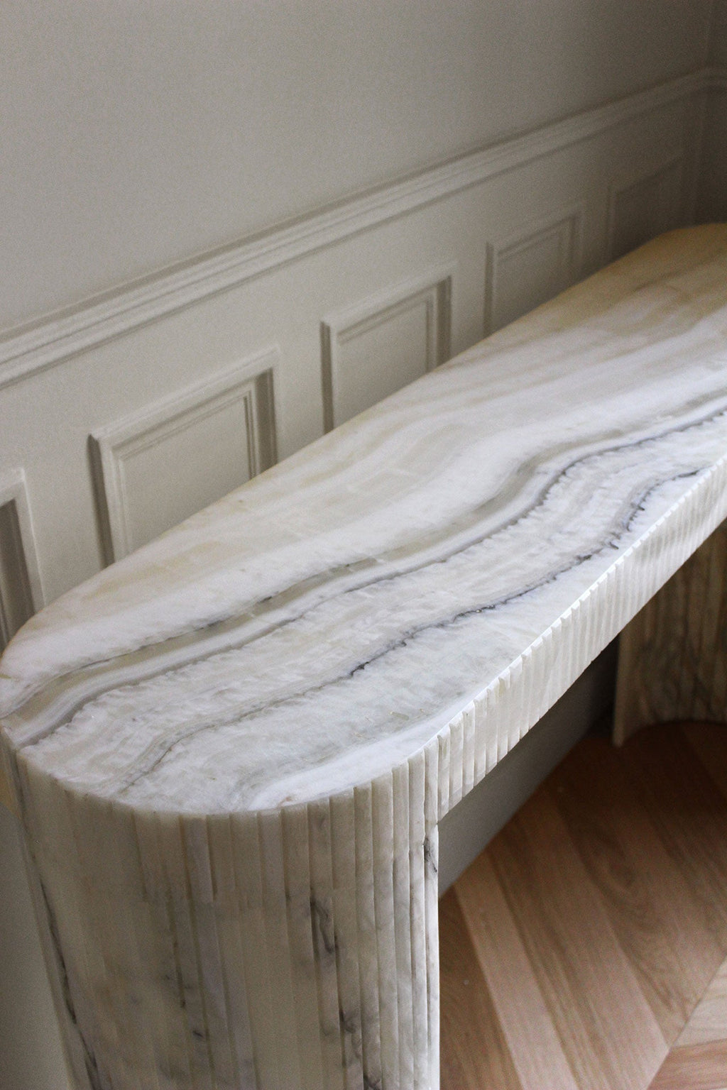Luna Montaigne Onyx console artistic view showcasing translucent cream onyx stone natural beauty