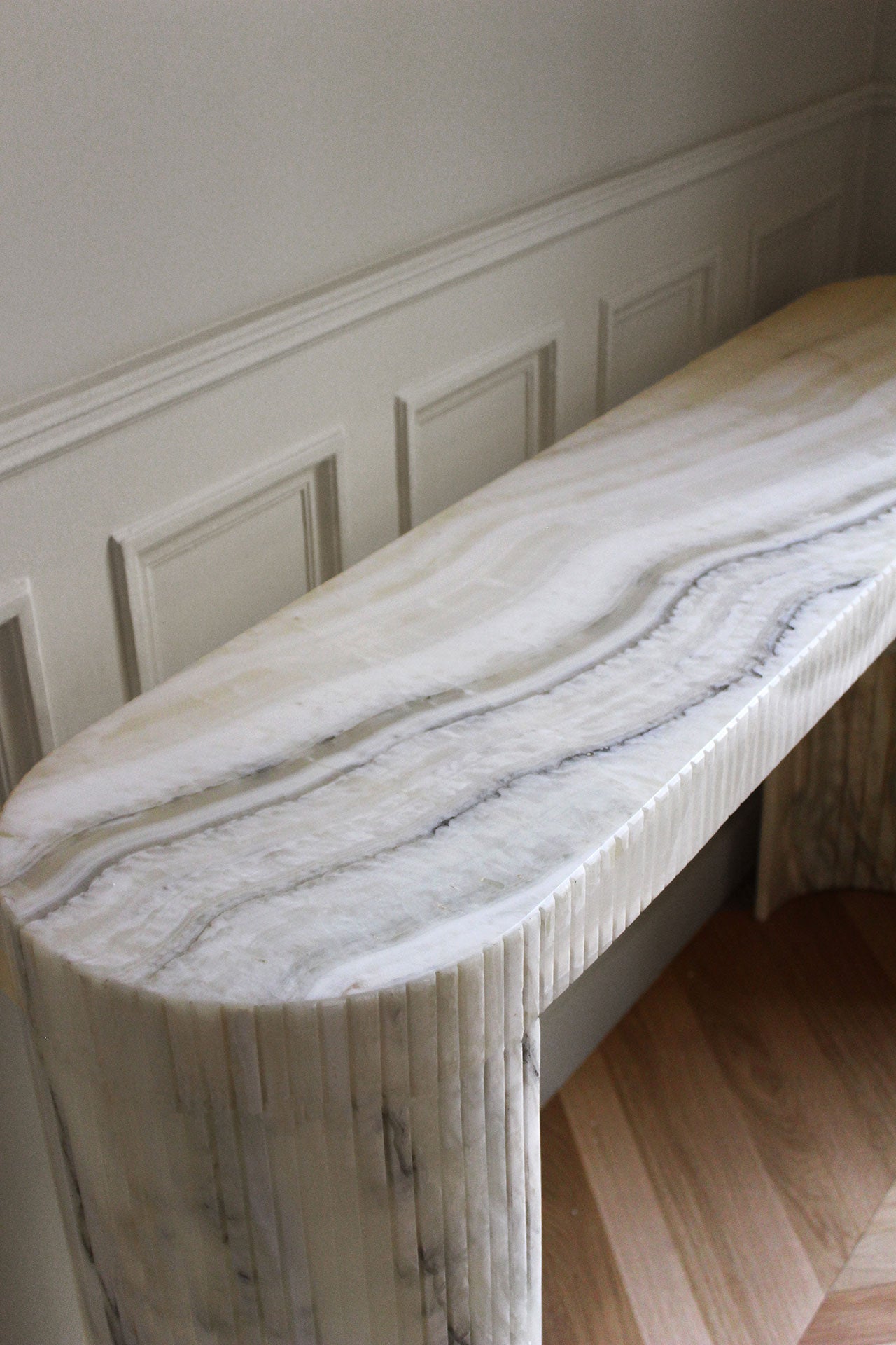 Luna Montaigne Onyx console artistic view showcasing translucent cream onyx stone natural beauty