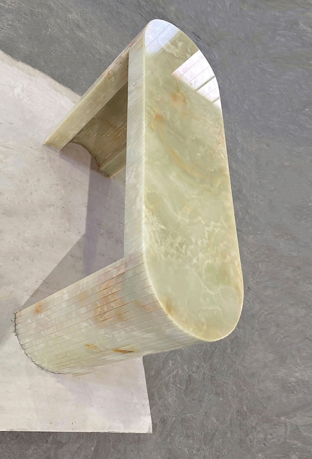 Luna Green Onyx console lifestyle setting showcasing translucent green onyx natural stone beauty