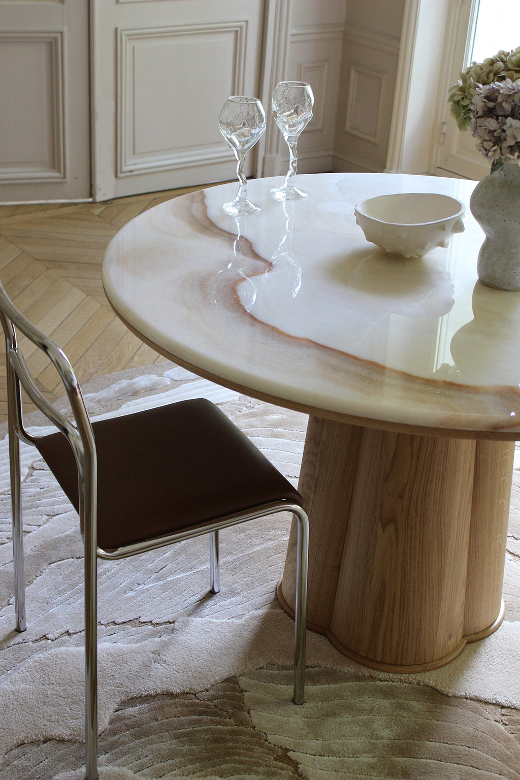 Back angle view of Poli luxury dining table with oak wood and vanilla onyx marble construction