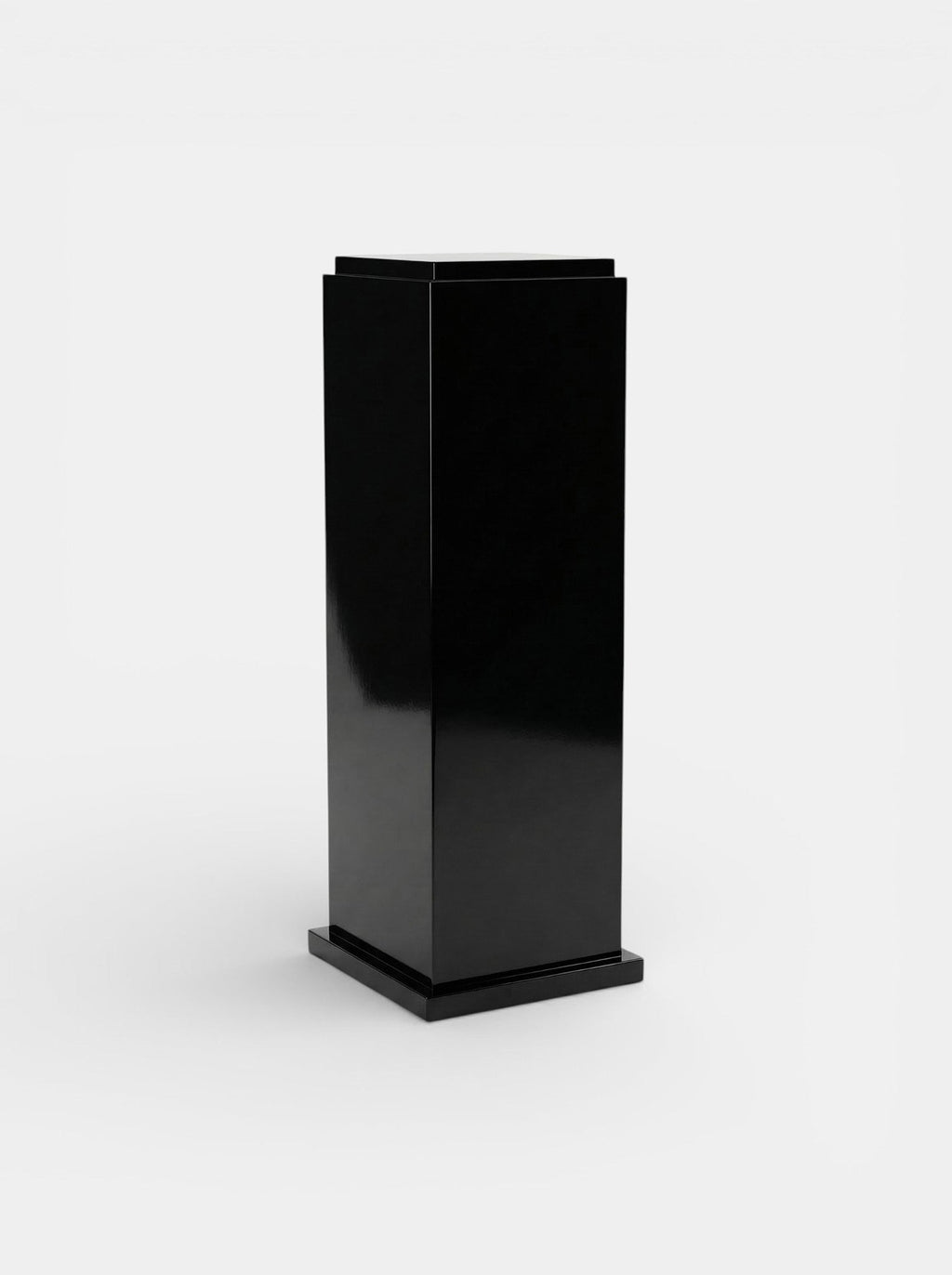 Italian black lacquered plinth front angle - premium furniture base with mirror-like surface