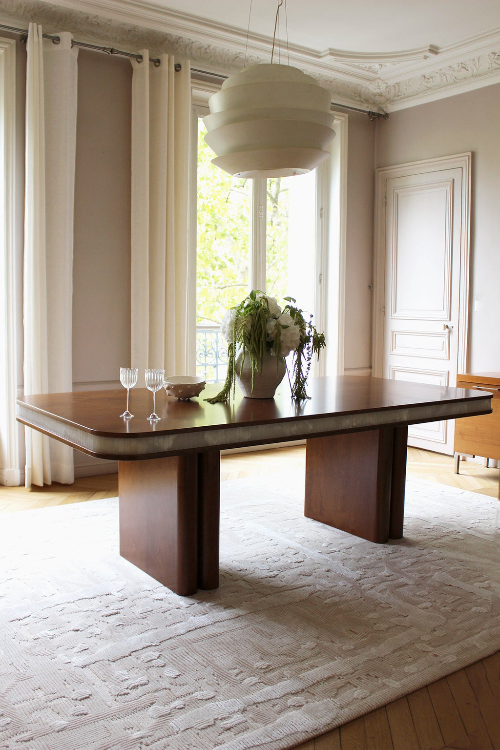 Angled view of Doppio dining table highlighting natural wood base with white onyx top - Italian luxury