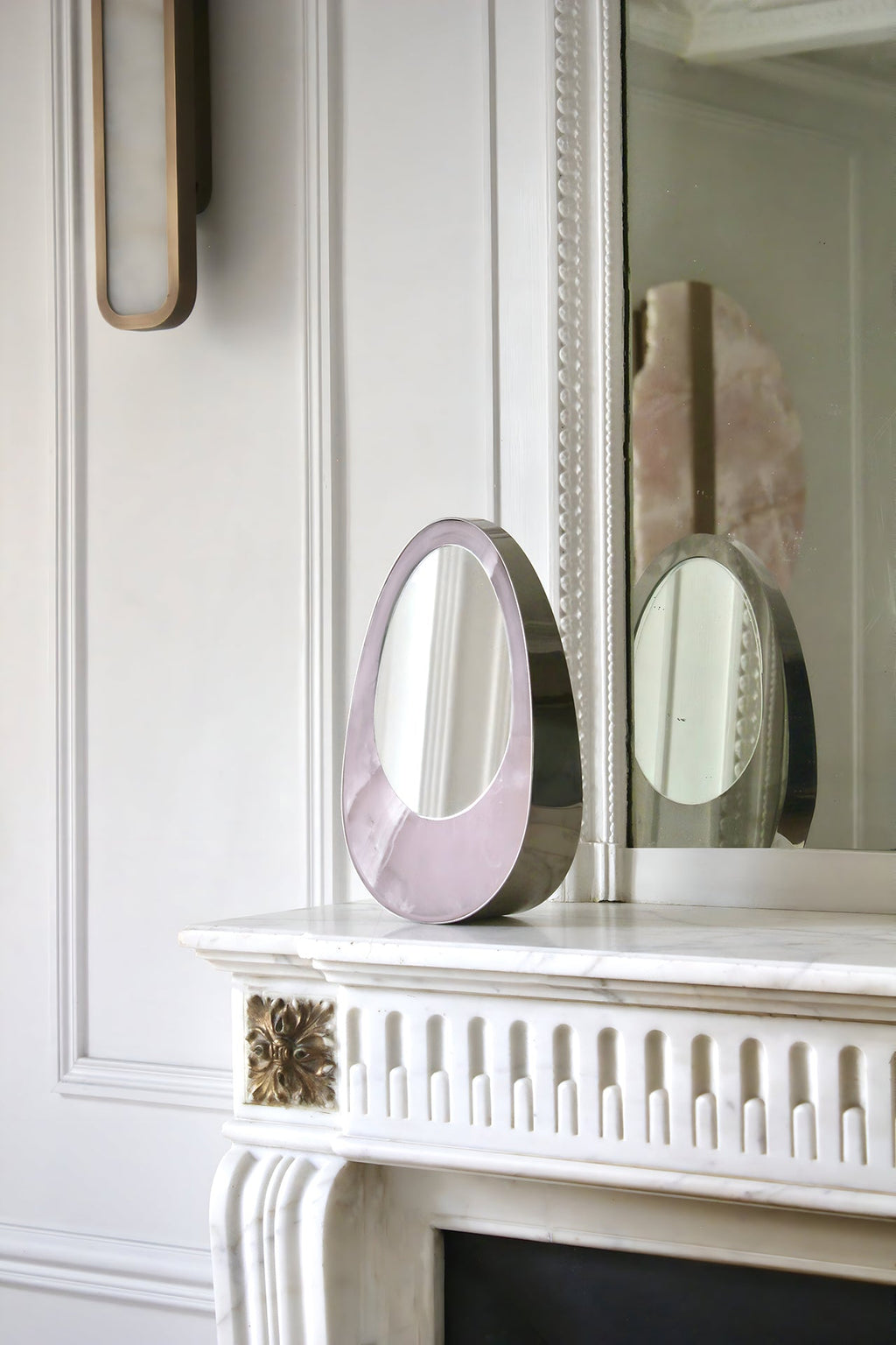 Close-up of Ovio mirror with marble frame details, Italian crafted luxury decorative furniture