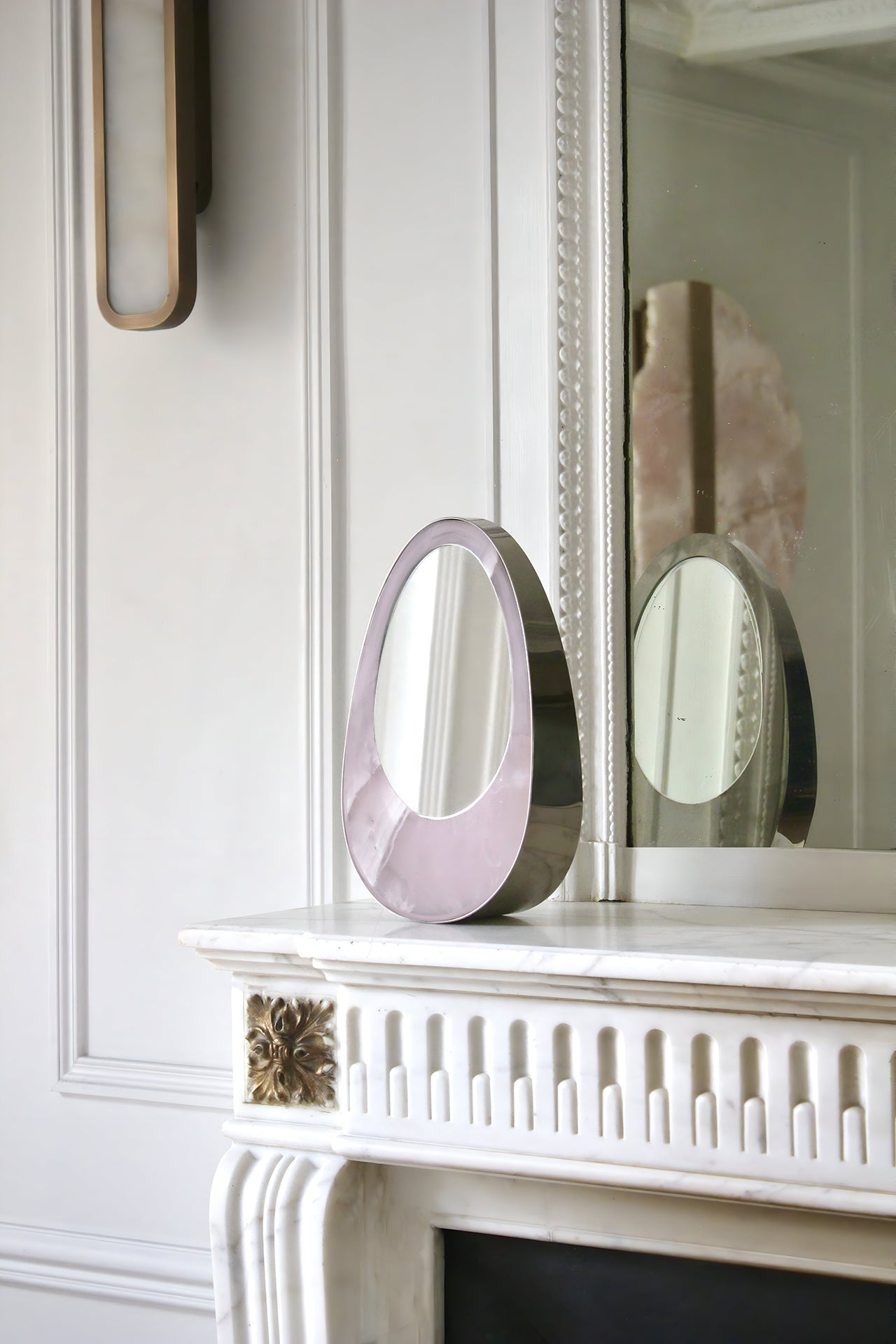 Close-up of Ovio mirror with marble frame details, Italian crafted luxury decorative furniture
