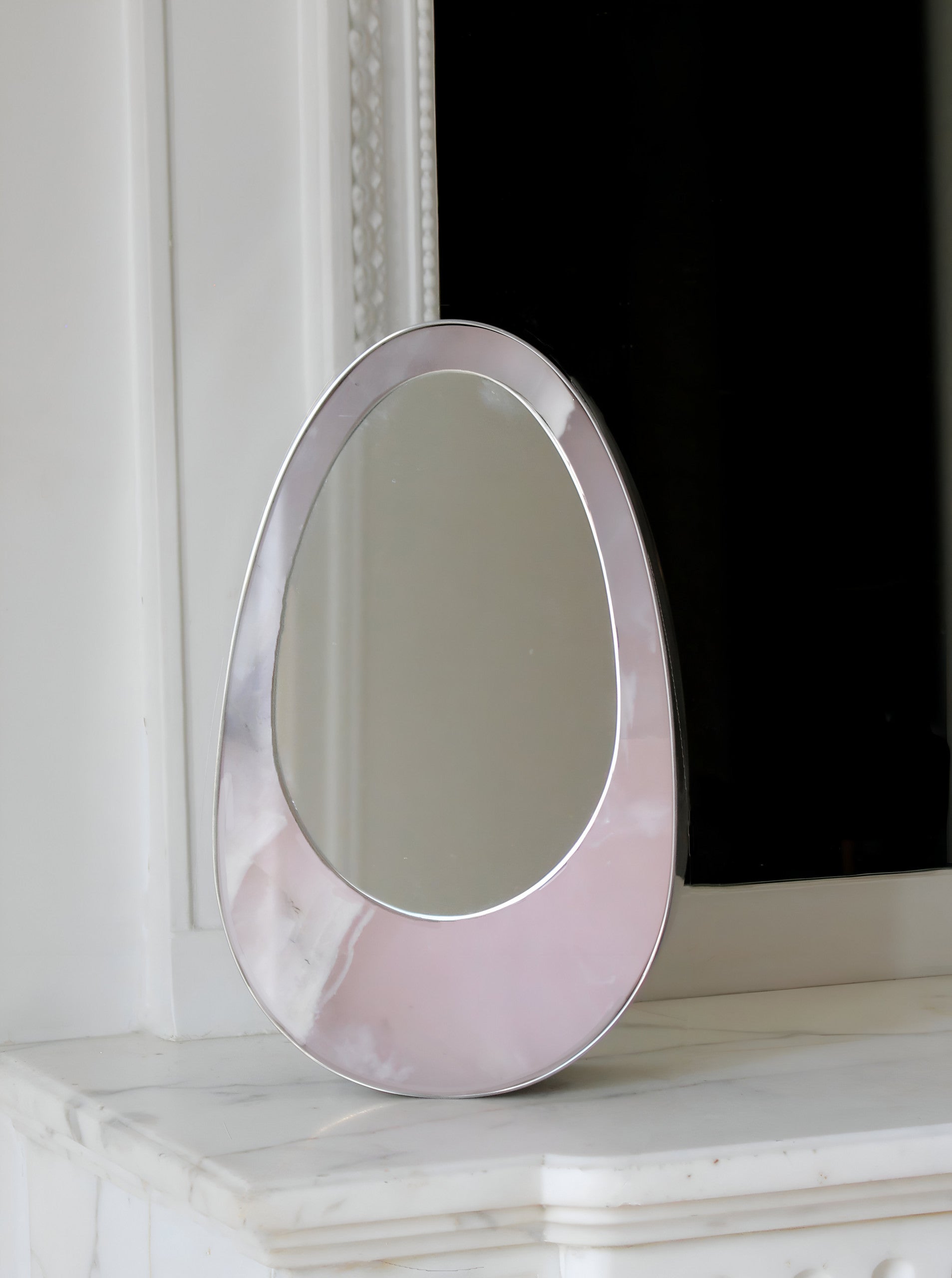 Detail view of Ovio marble mirror frame craftsmanship, Italian luxury decorative furniture design