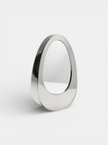 Left 3/4 view of Ovio luxury mirror with marble frame, Italian crafted decorative furniture piece