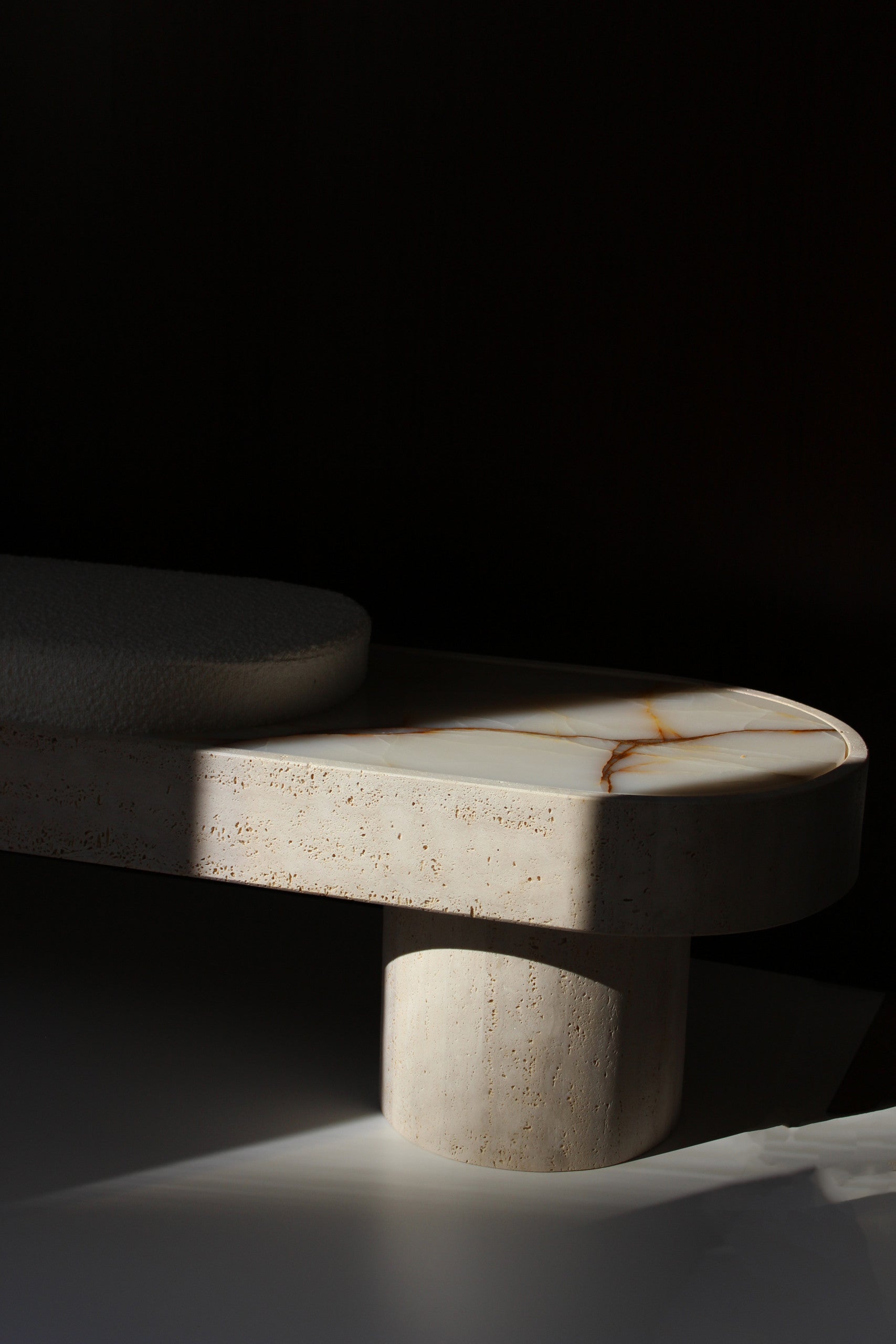 MARBERA Noto travertine bench bouclette upholstery - ambient lighting showcasing Italian design