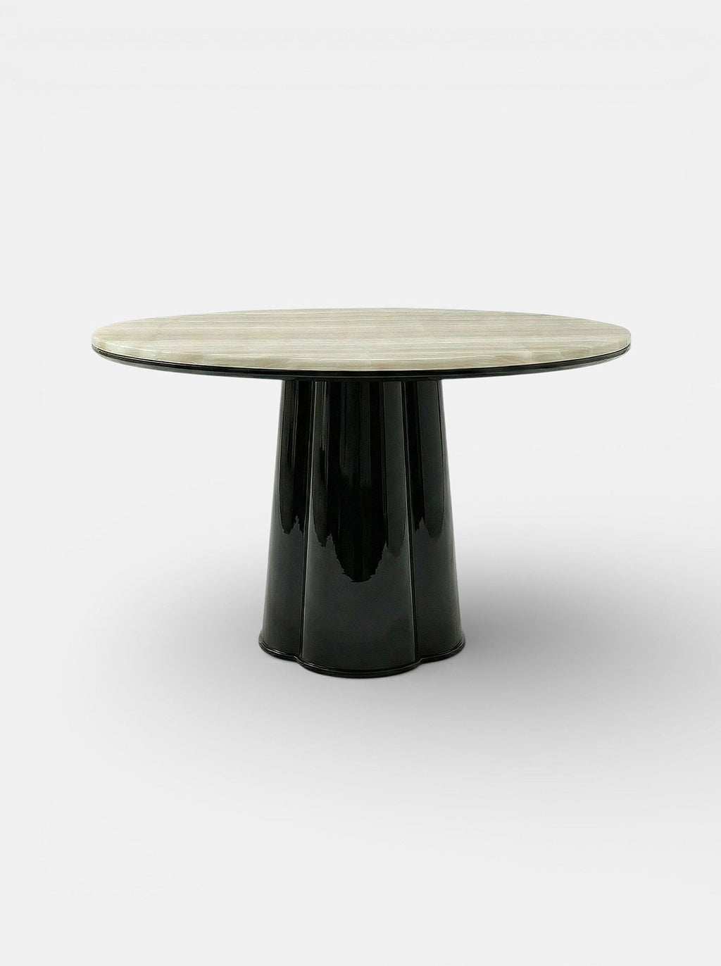 Side angle view of Poli luxury dining table featuring black lacquered finish and ivory onyx marble